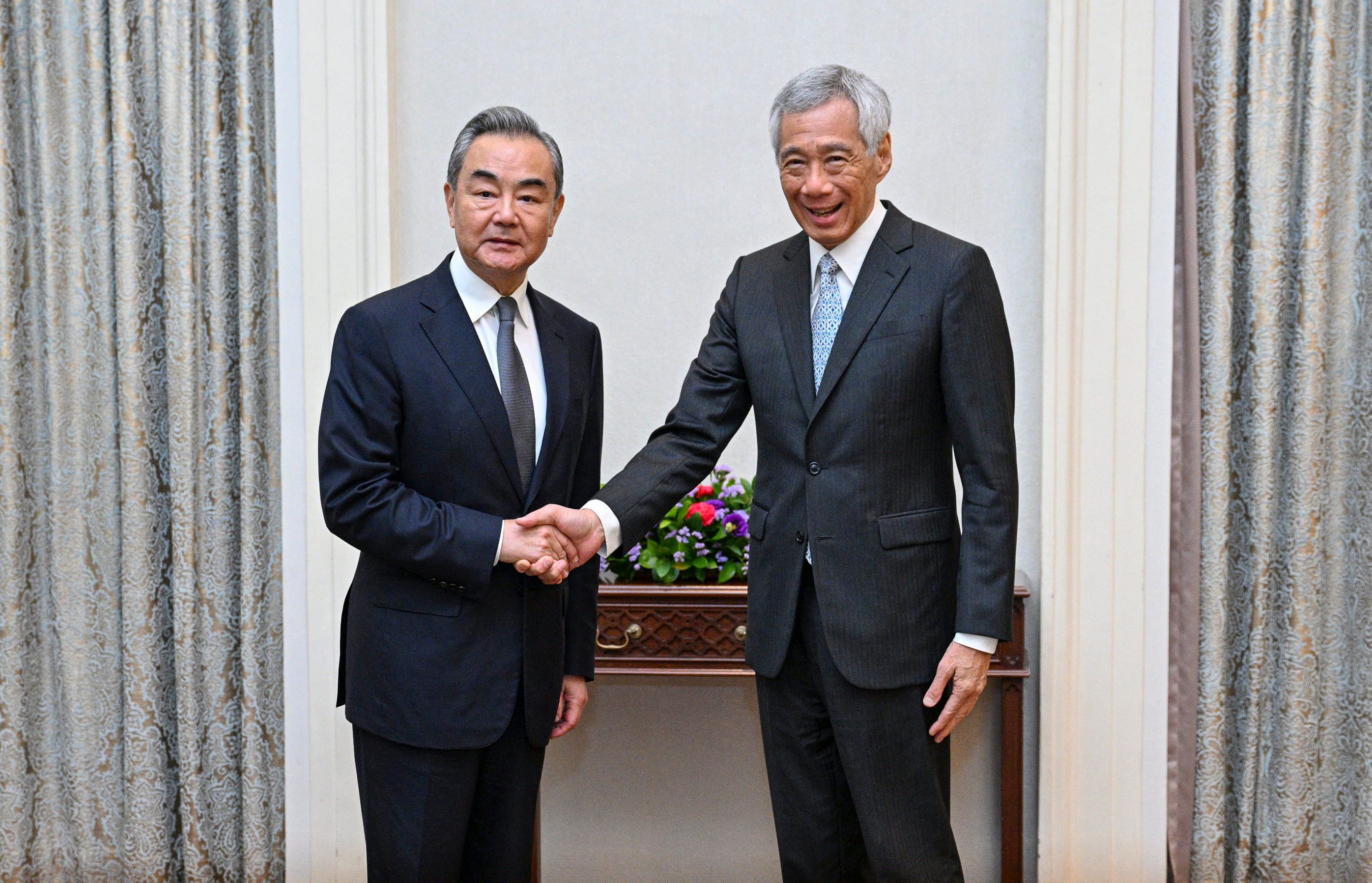 Chinese Foreign Minister Wang Yi (left) shakes hands with Singaporean Prime Minister Lee Hsien Loong in Singapore on Friday. Photo: Xinhua