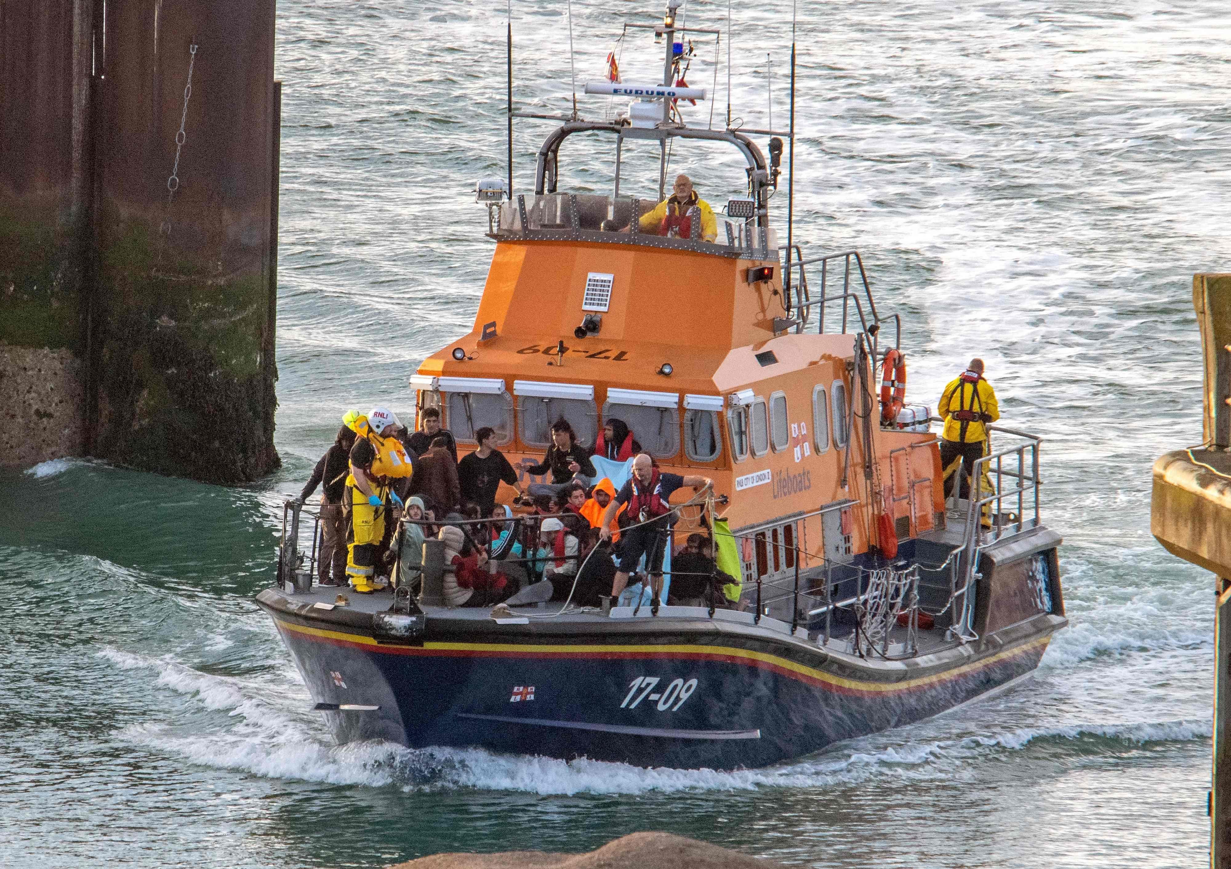 Paramedics help migrants picked up at sea while attempting to cross the English Channel, in Dover, southeast England on Saturday. Six Afghan males died when a migrant boat heading to Britain sank in the Channel early on Saturday. Photo: AFP