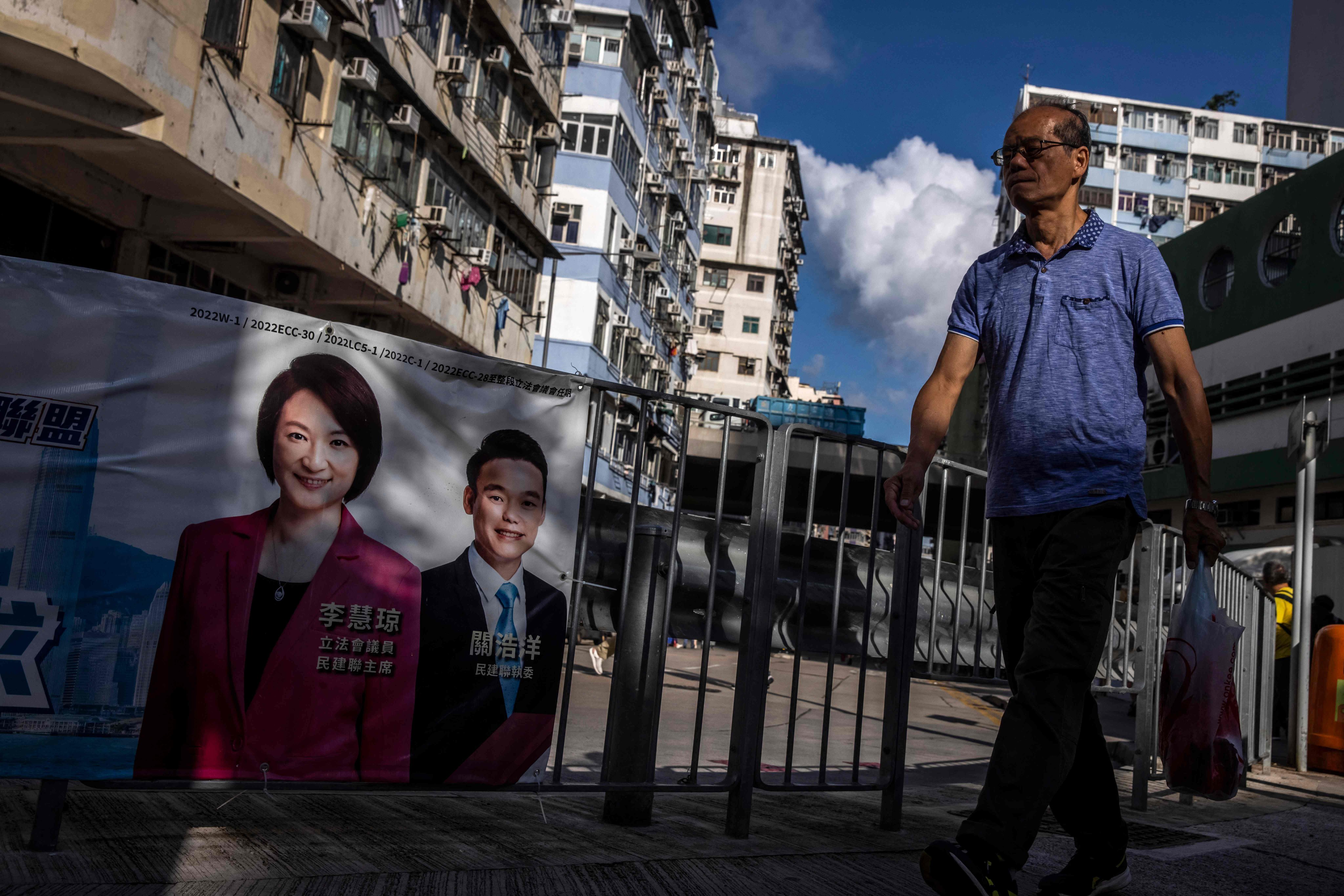 A man walks past a banner featuring Starry Lee, in To Kwa Wan on July 6, a constituency in Kowloon where she first won as an independent in 1999. She founded her political career in grass-roots and community work but now, district councillors have drastically diminished influence. Photo: AFP
