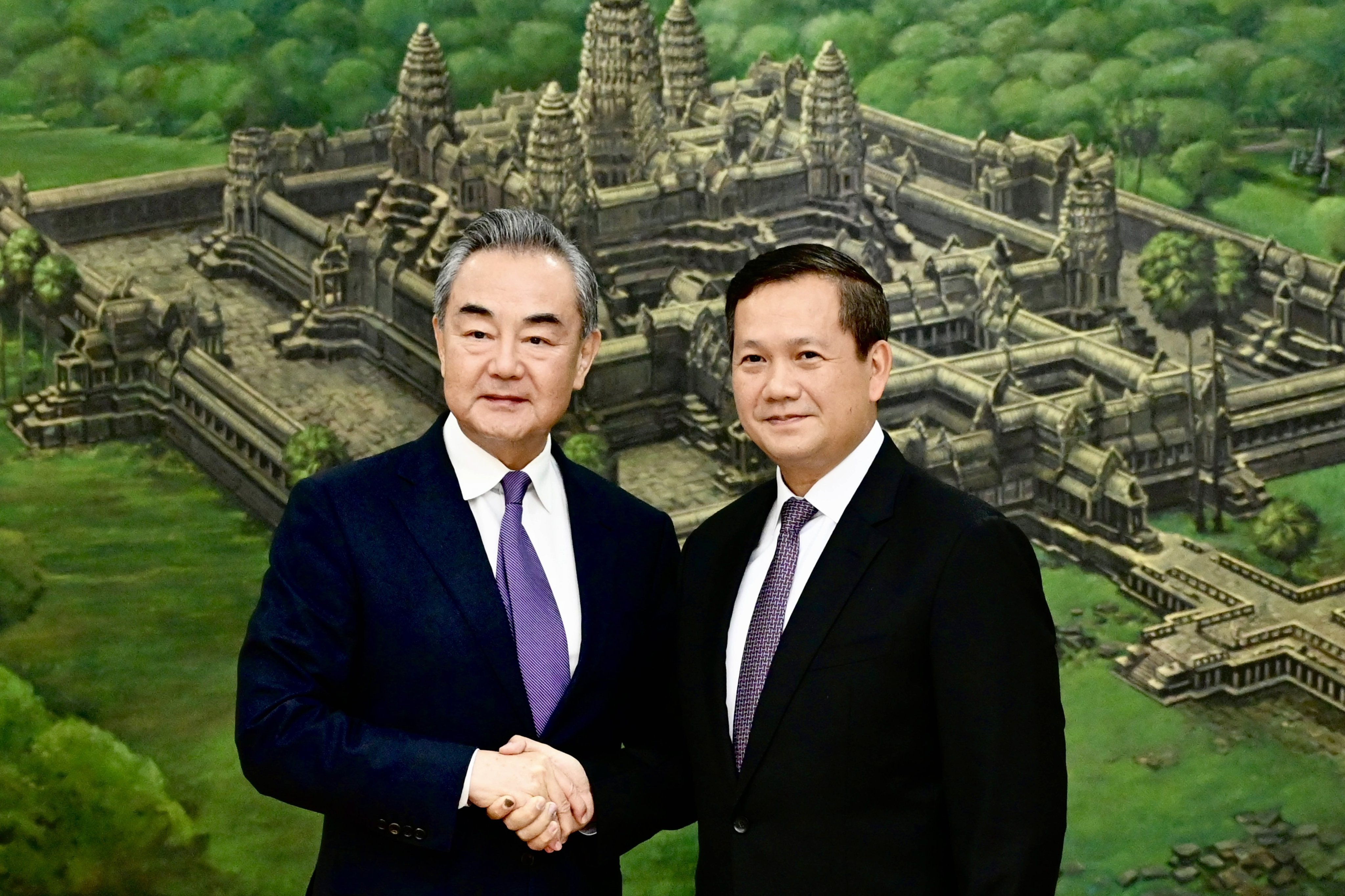 Hun Manet, designated as Cambodia new prime minister, right, shakes hands with Chinese Foreign Minister Wang Yi , during a meeting at the Peace Palace in Phnom Penh, Cambodia on Sunday, August 13, 2023. Wang Yi is on an official visit in Cambodia to tighten ties and cooperation between the two countries.  Photo: EPA-EFE