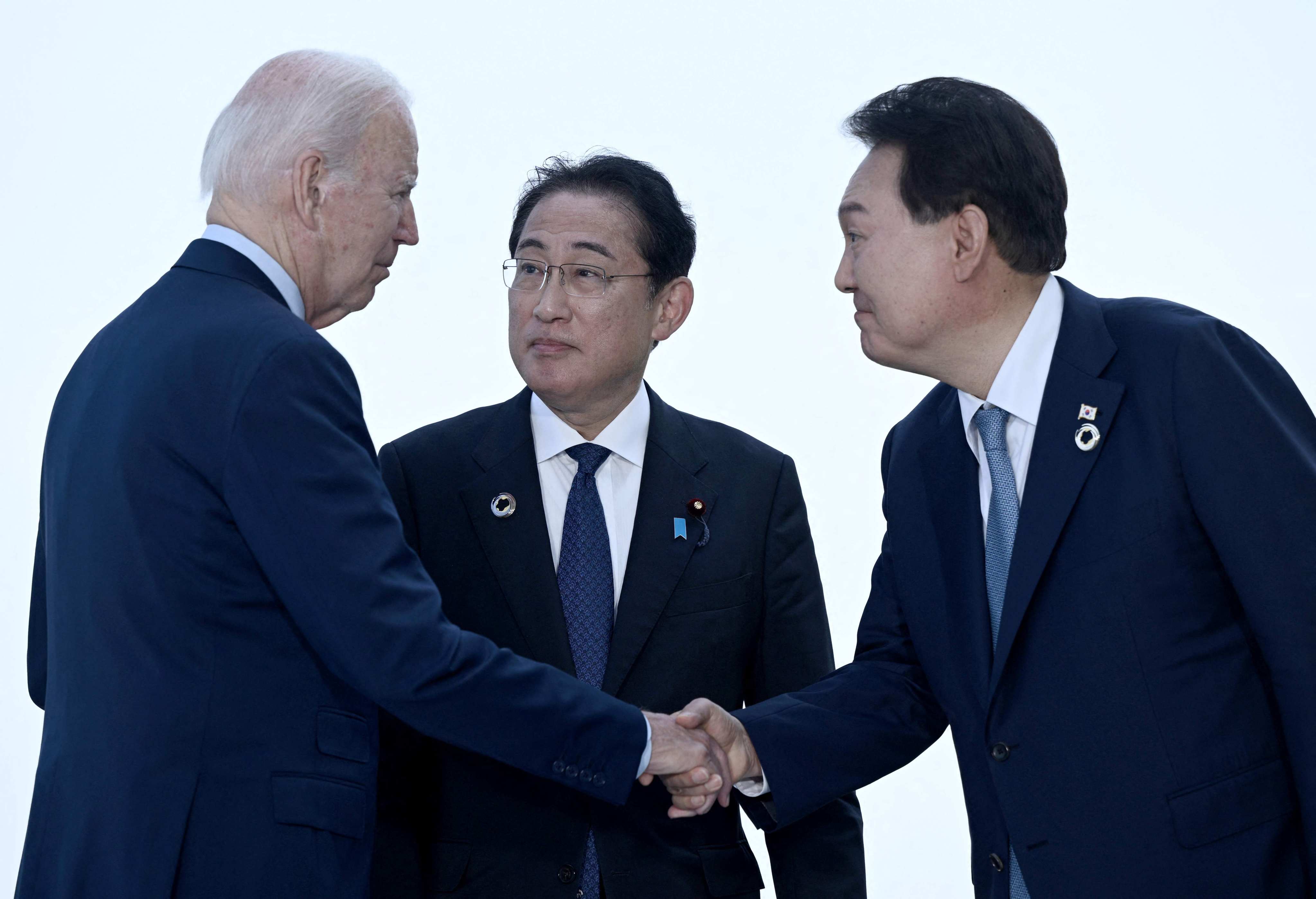 US President Joe Biden (far left) will be hosting Japanese Prime Minister Fumio Kishida (centre) and South Korean President Yoon Suk-yeol at Camp David on Friday. Photo: AFP