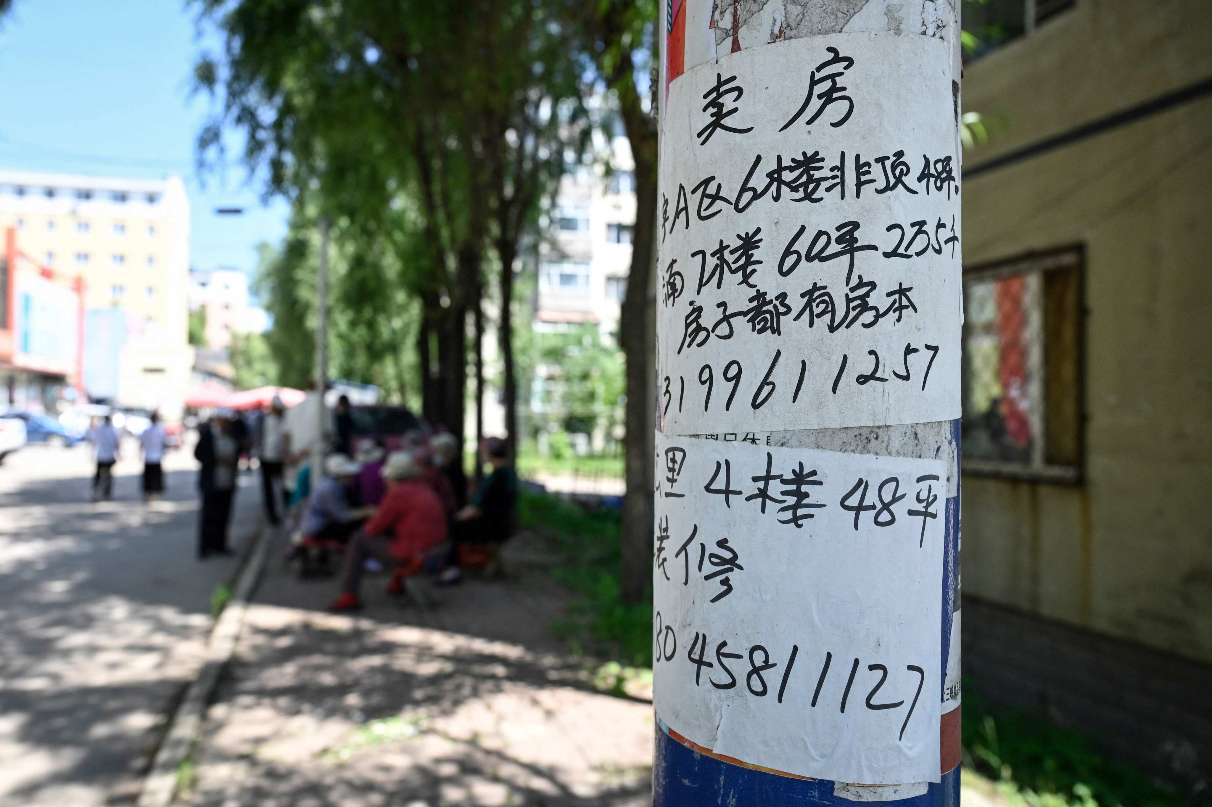 An advertisement for an apartment for sale is posted on a telegraph pole in a residential compound in Hegang city in northeastern China’s Heilongjiang province on July 4.  Retail sales data in July showed that Chinese consumers were still spending in sectors such as catering, but they are cutting back on housing-related spending. Photo: AFP