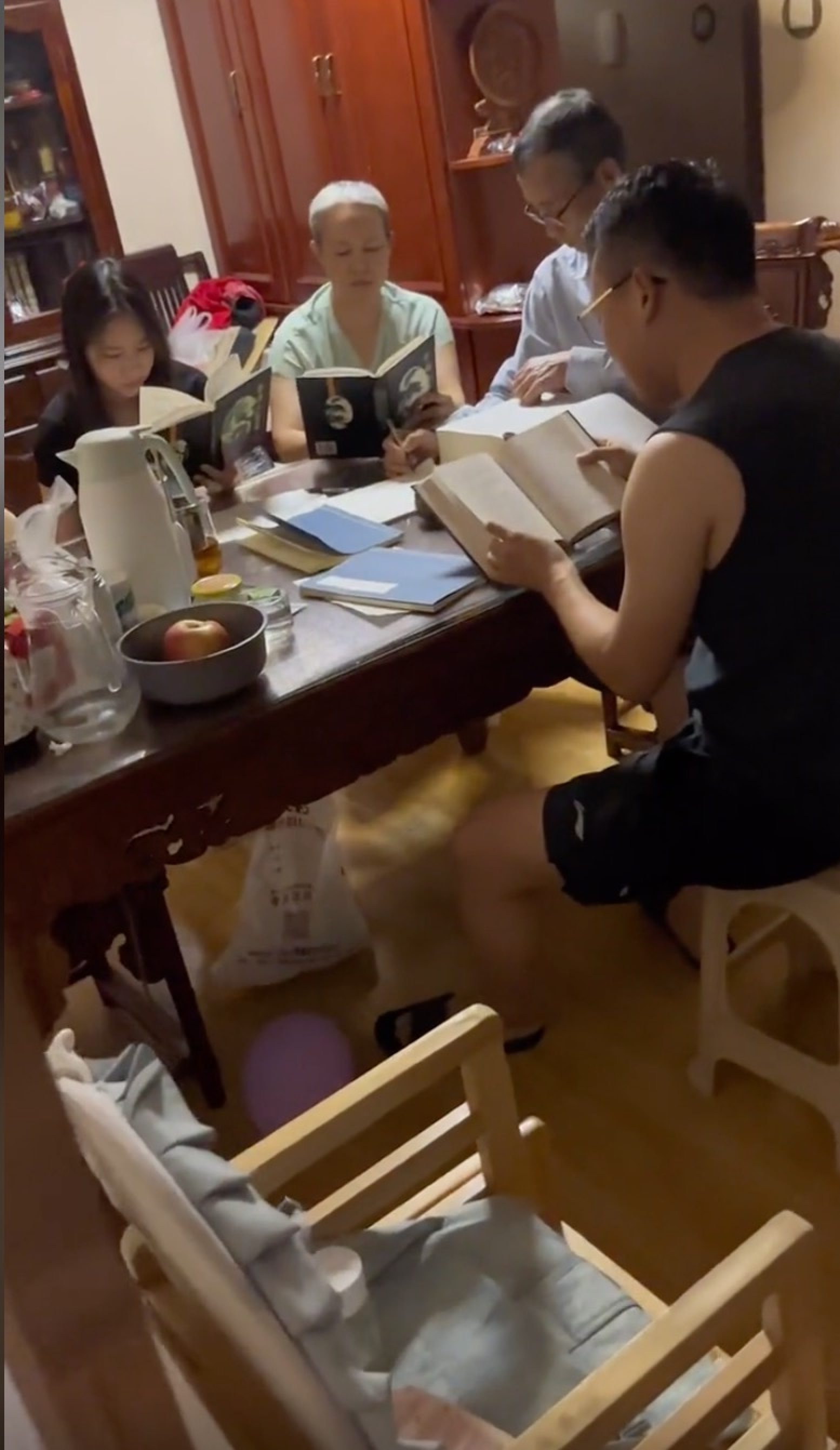 Studying hard: older and younger members of the family captured on video during their baby-name finding marathon. Photo: Douyin