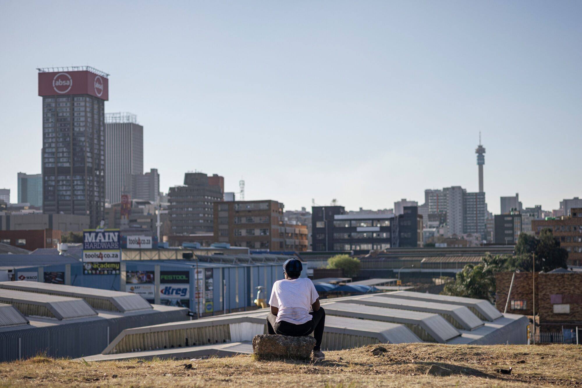A resident looks out towards the skyline of the central business district in Johannesburg, South Africa, on August 15. The Brics summit will take place in the city from August 22-24, with plans to expand the bloc’s membership encountering resistance over concerns about diluting influence and complicating policymaking. Photo: Bloomberg