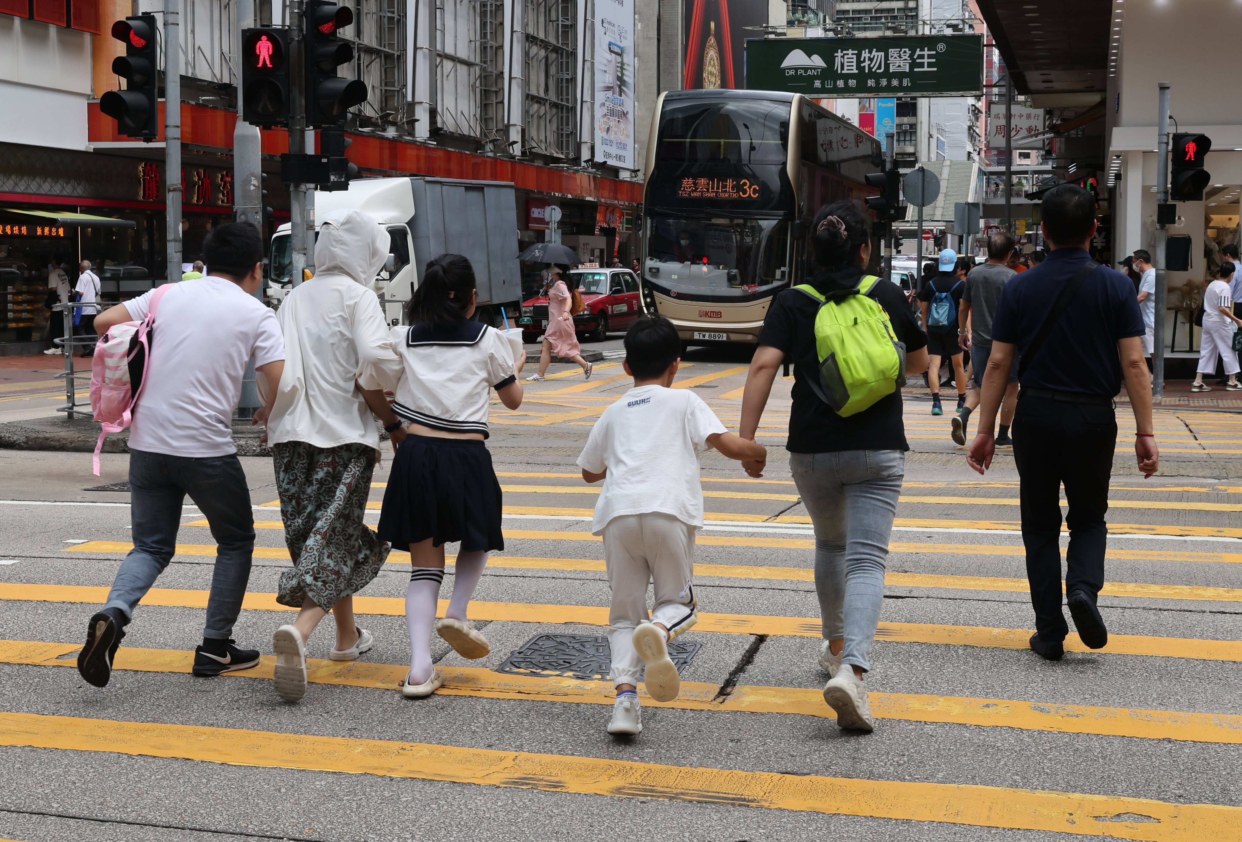 Pedestrians cross the road against a red signal in Mong Kok on August 14. The city’s police force has said it will step up enforcement action against unsafe behaviour by pedestrians and drivers after a series of accidents. Photo: Yik Yeung-man