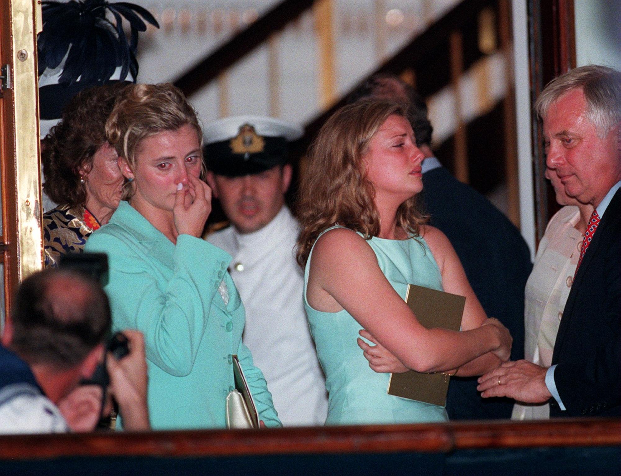 (From left) Laura and Kate Patten stand alongside their father Chris Patten on board the Royal Yacht Britannia as they leave Hong Kong in 1997. Photo: K. Y. Cheng