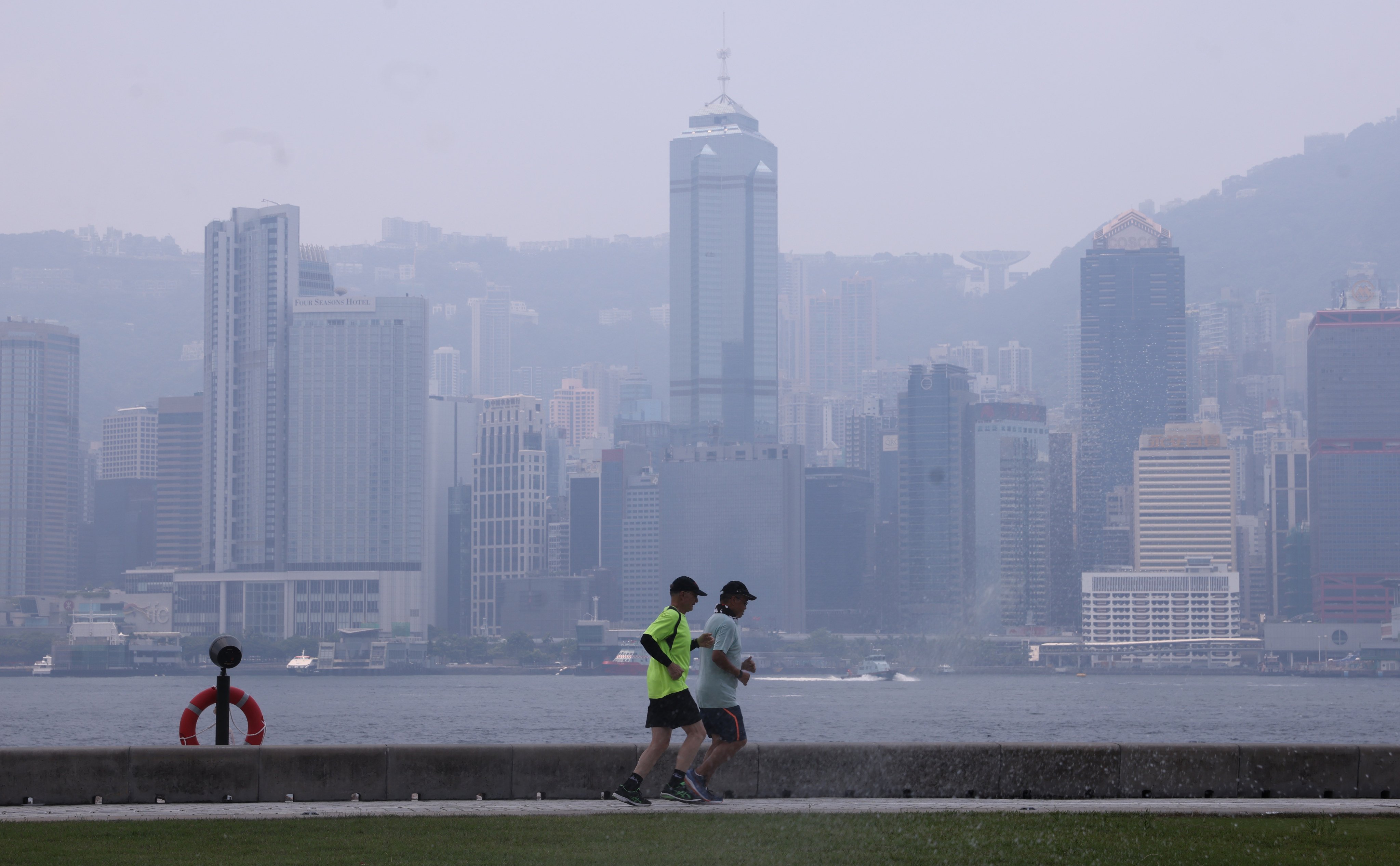 Joggers at the West Kowloon Art Park on July 26, a particularly smoggy day due to a typhoon in the region. Photo: May Tse