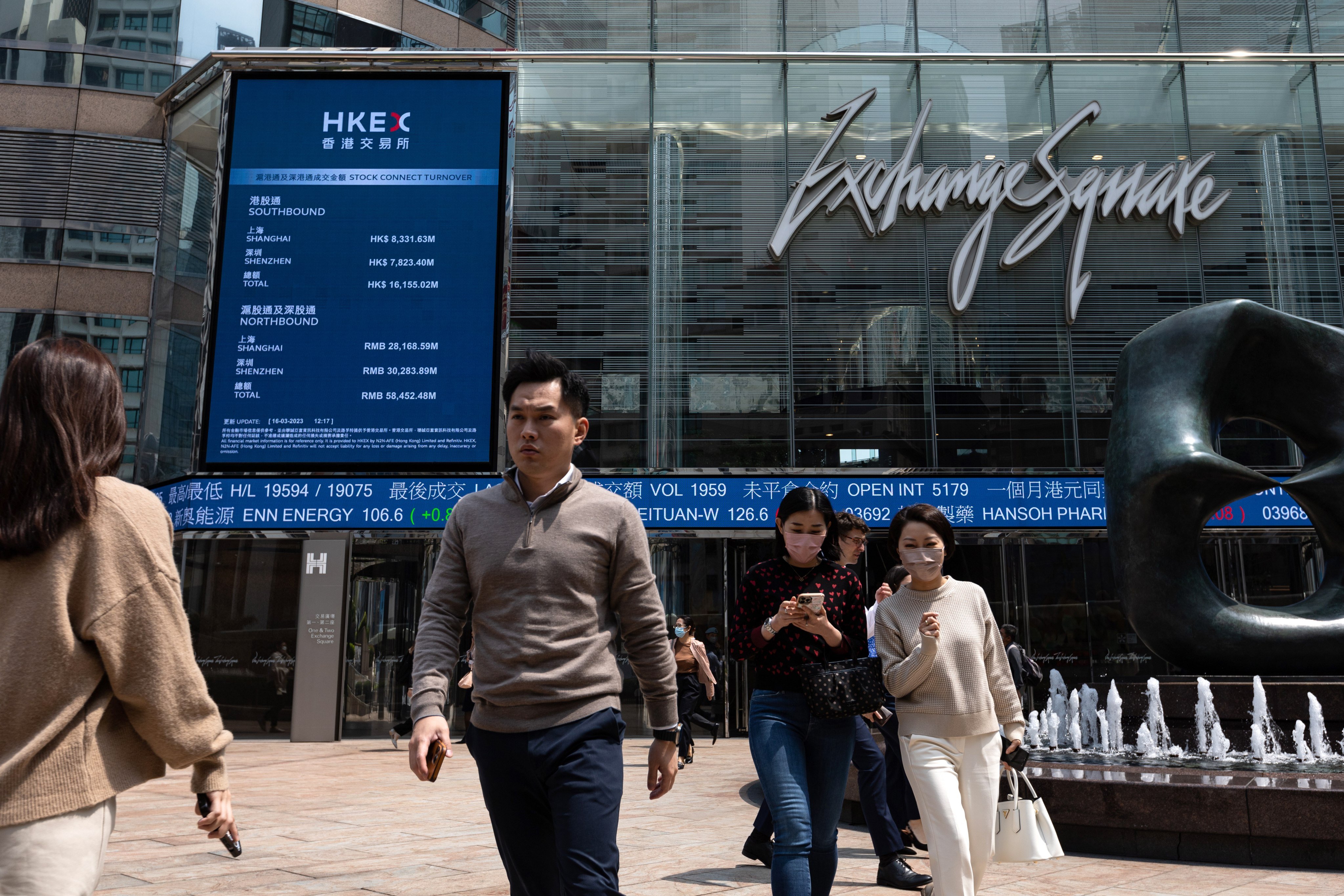 Pedestrians walk past a stock ticker outside Exchange Square. Hong Kong’s stock market is Asia’s third largest after China and Japan. Photo: EPA-EFE