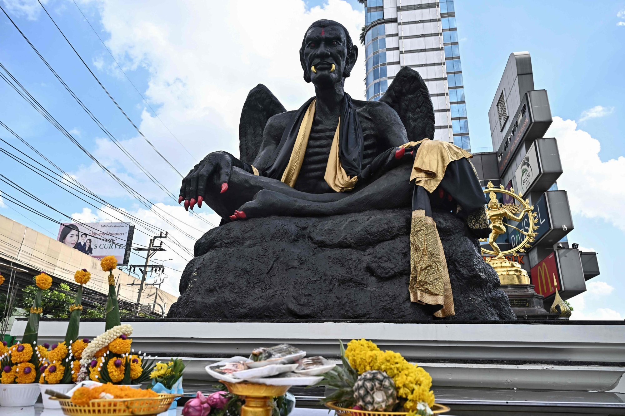 A giant statue of the deity Kru Kai Kaew – huge emaciated, winged figure with golden fangs and scarlet talons –outside the Bazaar Hotel in Bangkok. Photo: AFP