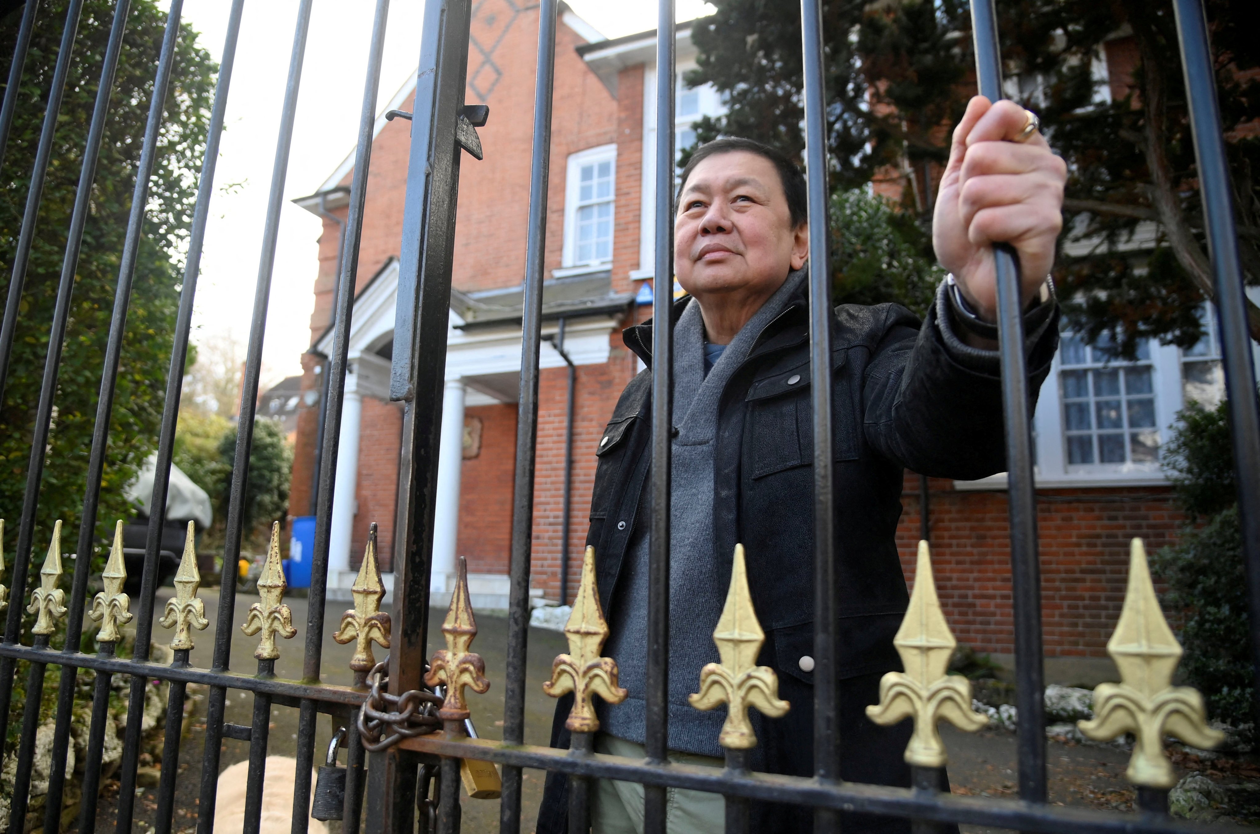 Ex-ambassador of Myanmar to Britain, Kyaw Zwar Minn stands by the gates of the diplomatic residence where he has remained for almost two years since a new regime tried to evict him. Photo: Reuters