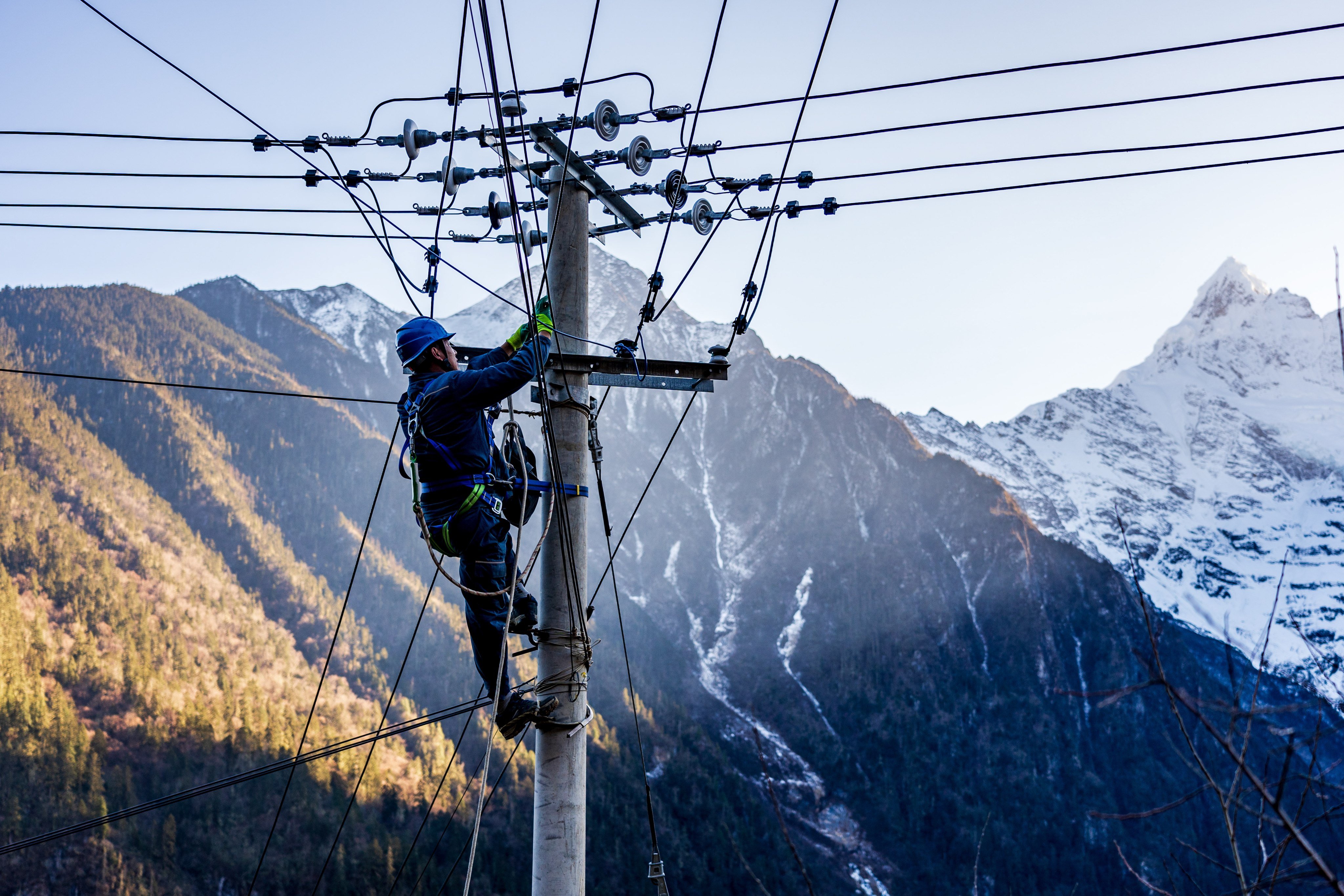 A China Southern Power Grid worker inspects transmission lines in Yubeng village, Deqen county, Yunnan province on January 9. The company recently agreed to buy  an Italian utility company’s Peruvian assets for US$2.9 billion, in what looks to be the biggest outbound deal of the year. Photo: EPA-EFE