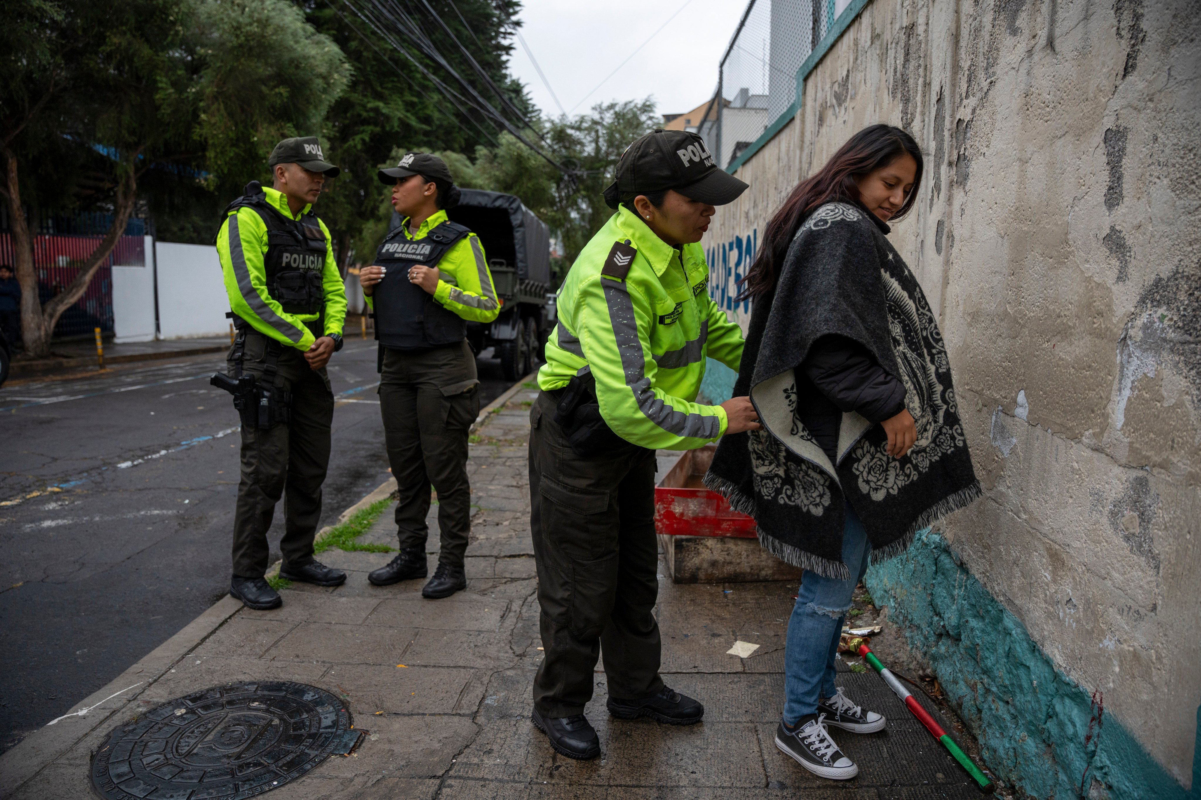 Police frisk a voter during a snap presidential election in Quito, Ecuador, on Sunday. Photo: AP