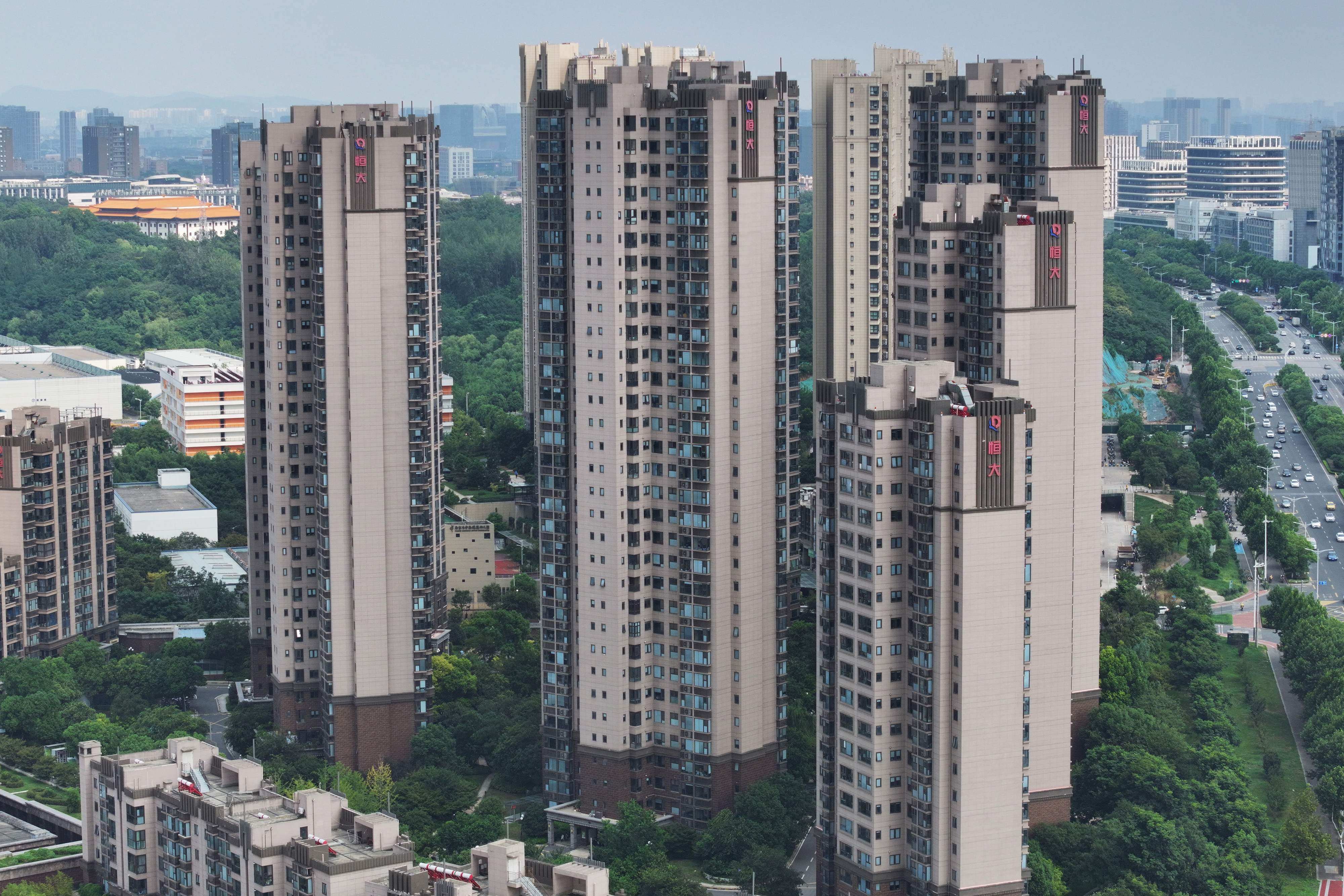 The China Evergrande Group logo is seen on residential buildings in Nanjing, in eastern Jiangsu province, on August 18. The embattled Chinese property giant filed for bankruptcy protection in the United States on August 17, court documents showed, a measure that protects its US assets while it pursues a restructuring deal. Photo: AFP