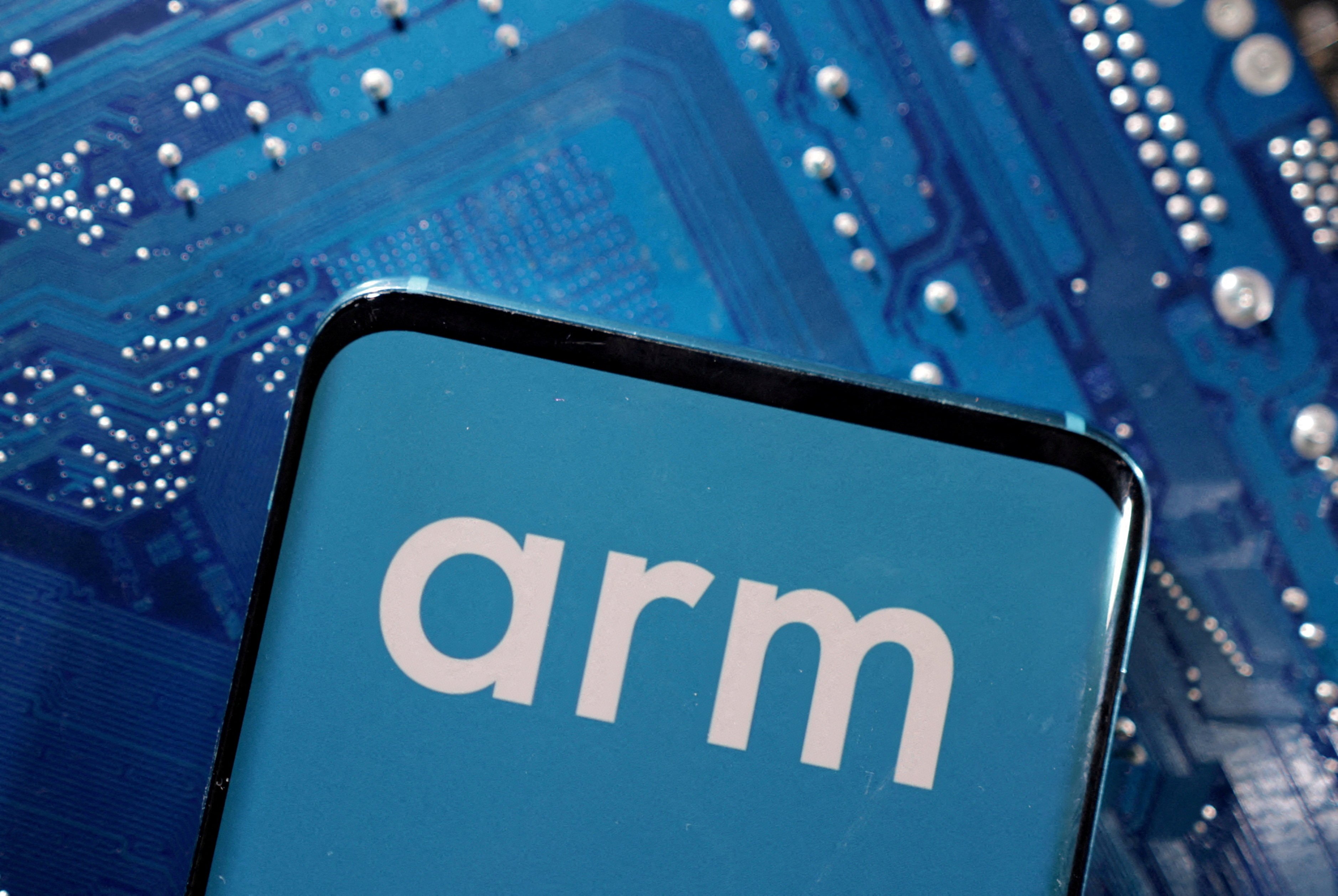 A smartphone with a displayed Arm logo placed on a computer motherboard in this illustration taken on March 6, 2023. Photo: Reuters