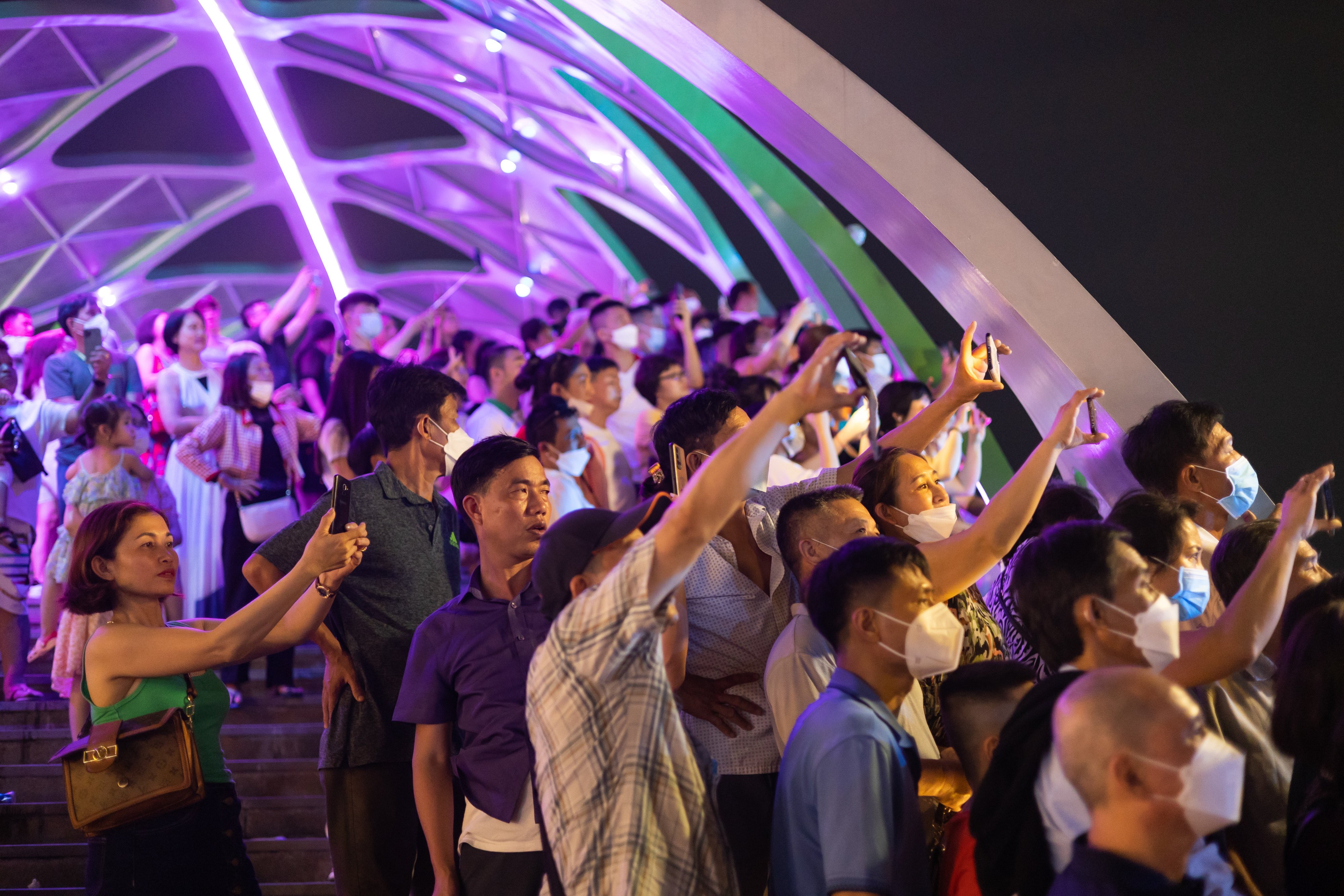People use their smartphones to photograph a light show in Phu Quoc, Vietnam. Photo: Bloomberg