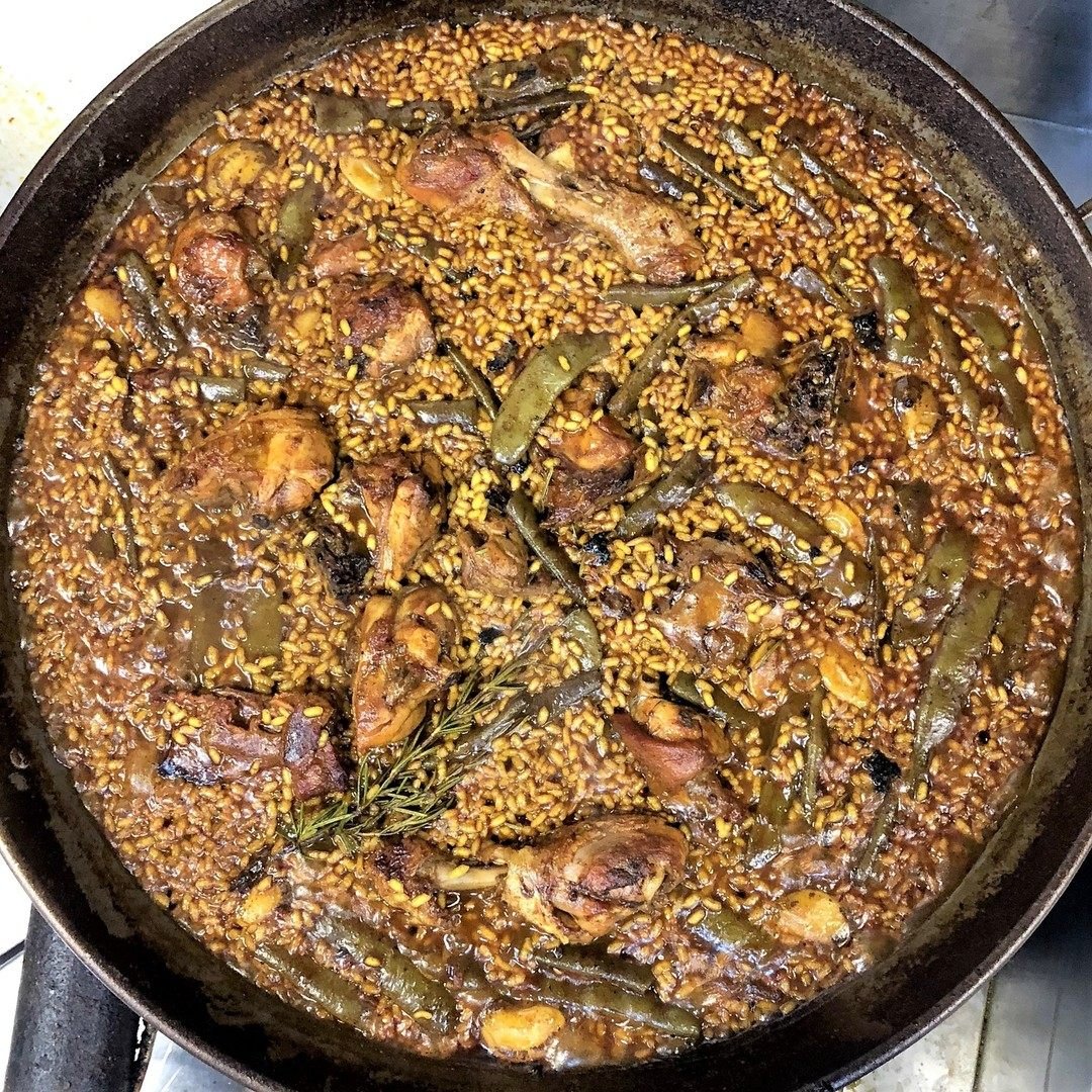 An authentic Valencian paella, with butter beans, ferradura beans, chicken and rabbit, at well-known Valencia paella restaurant Palace Fesol. Photo: Instagram/@palacefesolrestaurante