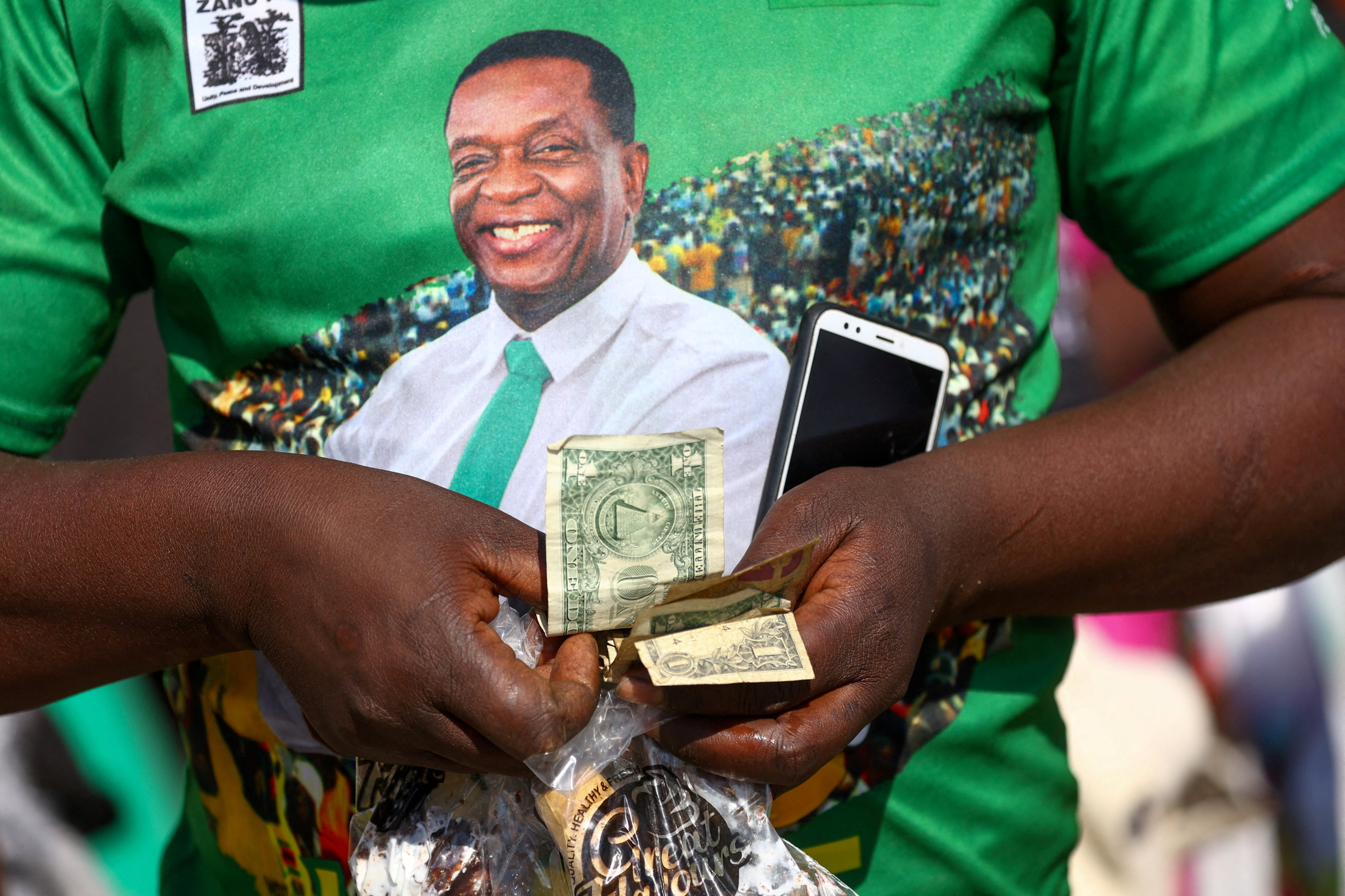 The face of President Emmerson Mnangagwa is pictured on a man’s shirt. Mnangagwa  is seeking a second term. Photo: Reuters