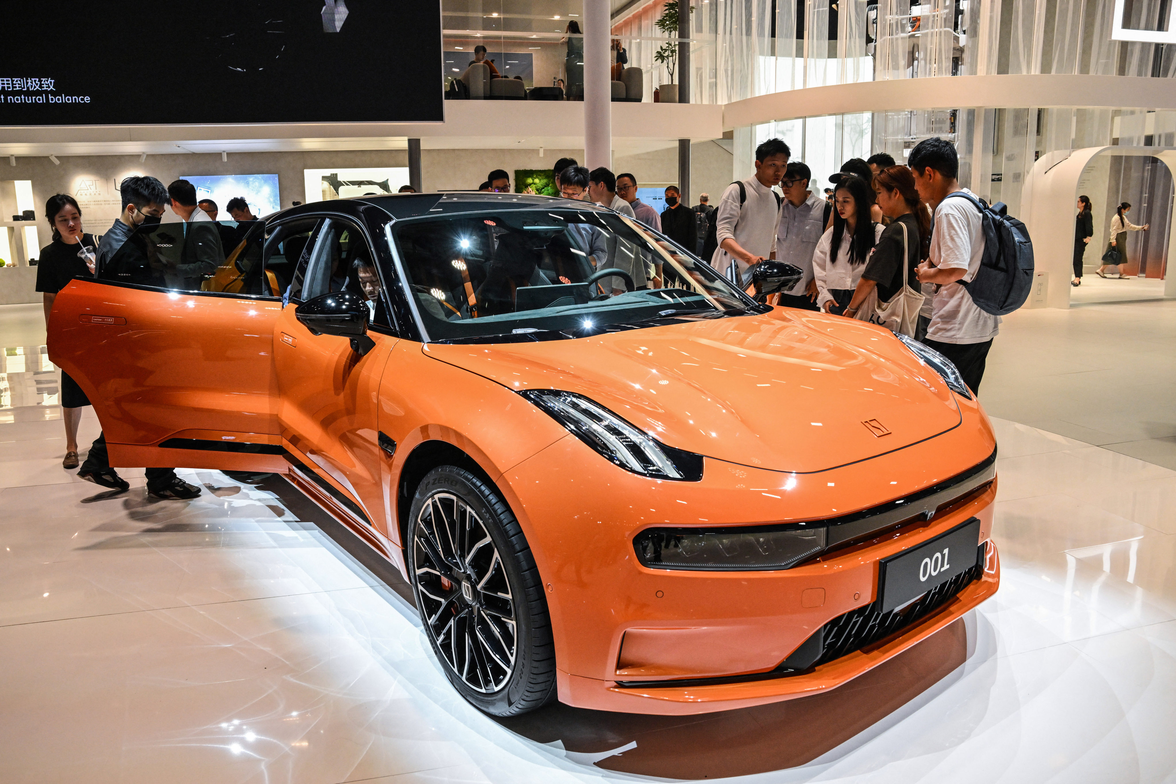 A Zeekr 001 is displayed during the 20th Shanghai International Automobile Industry Exhibition in this file photo from April 2023. A higher delivery volume will result in economies of scale, Geely Auto’s CEO says. Photo: AFP