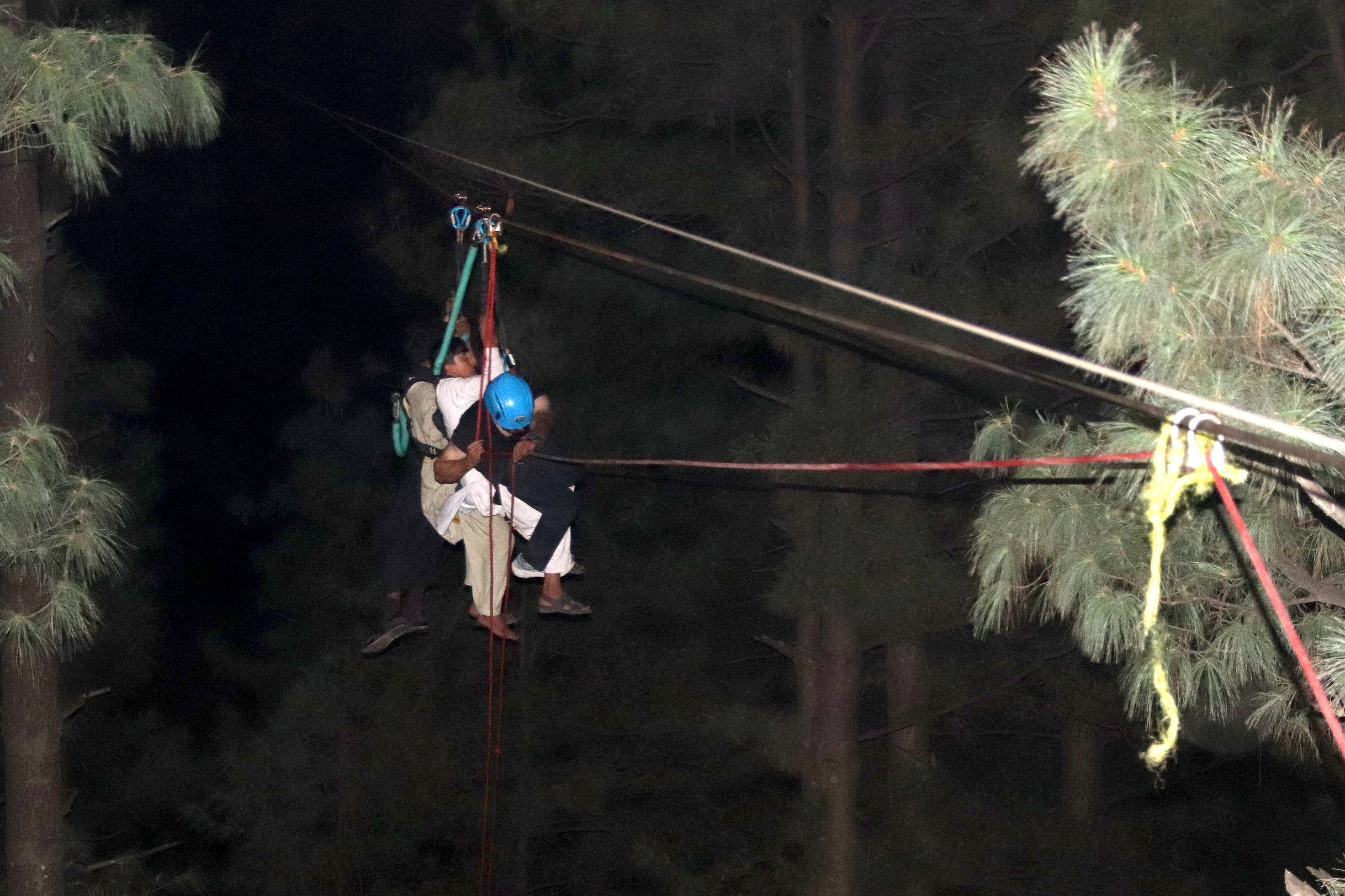 Pakistani soldiers carry out rescue operation for children stranded in a chairlift in Battagram district, Khyber Pakhtunkhwa province on Tuesday. Photo: EPA-EFE