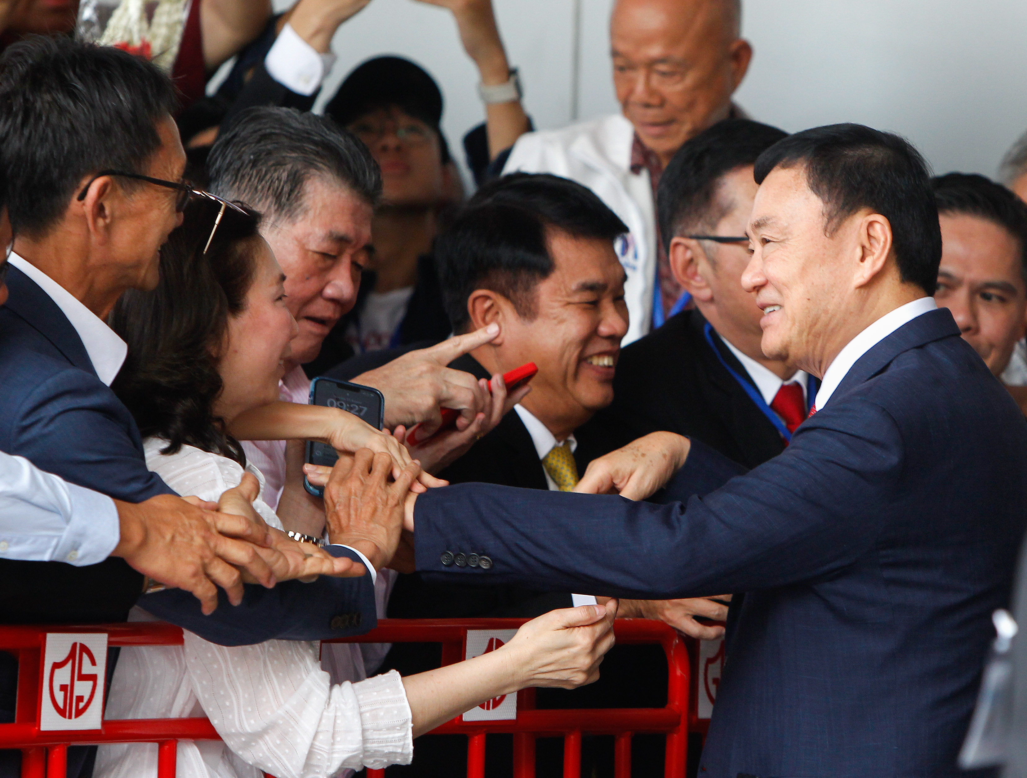 Former Thai prime minister Thaksin Shinawatra greets his supporters as he arrives at Don Mueang airport on Tuesday. Photo: Zuma Press Wire/dpa