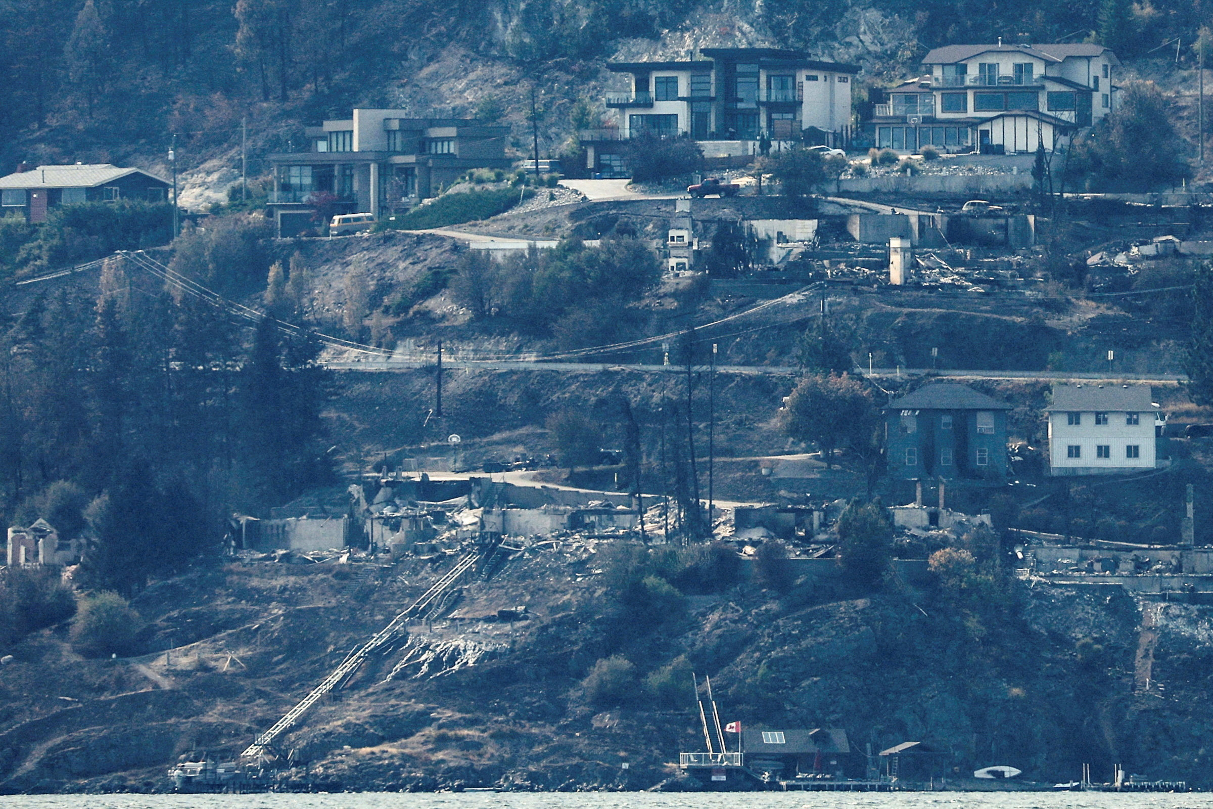 Destroyed houses are seen from across Lake Okanagan almost a week after the McDougall Creek burned through the community of West Kelowna, British Columbia, Canada, on Thursday. Photo: Reuters
