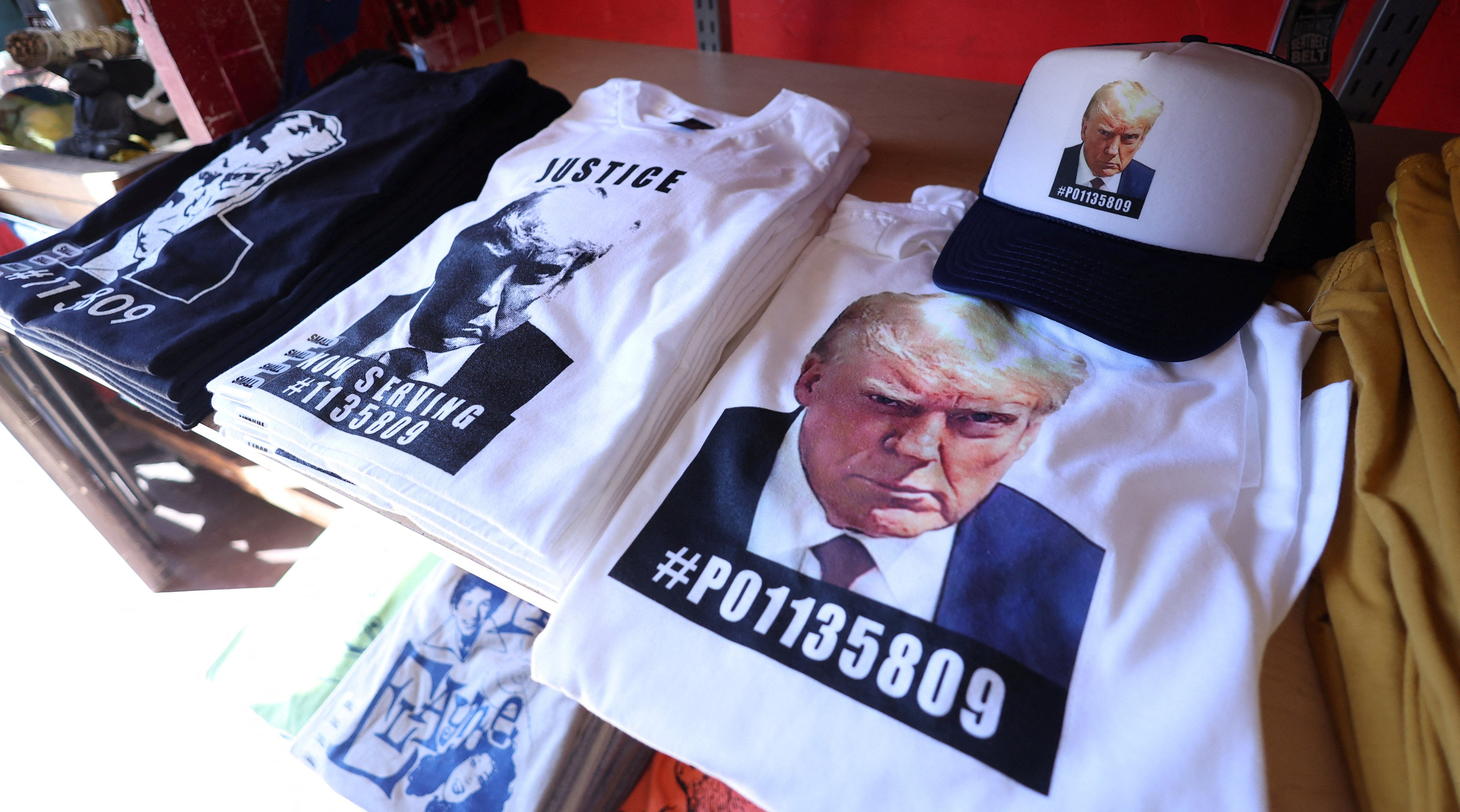 T-shirts and hats with an image depicting the mugshot of former US President Donald Trump are pictured after being printed at a store in LA. Photo: Reuters