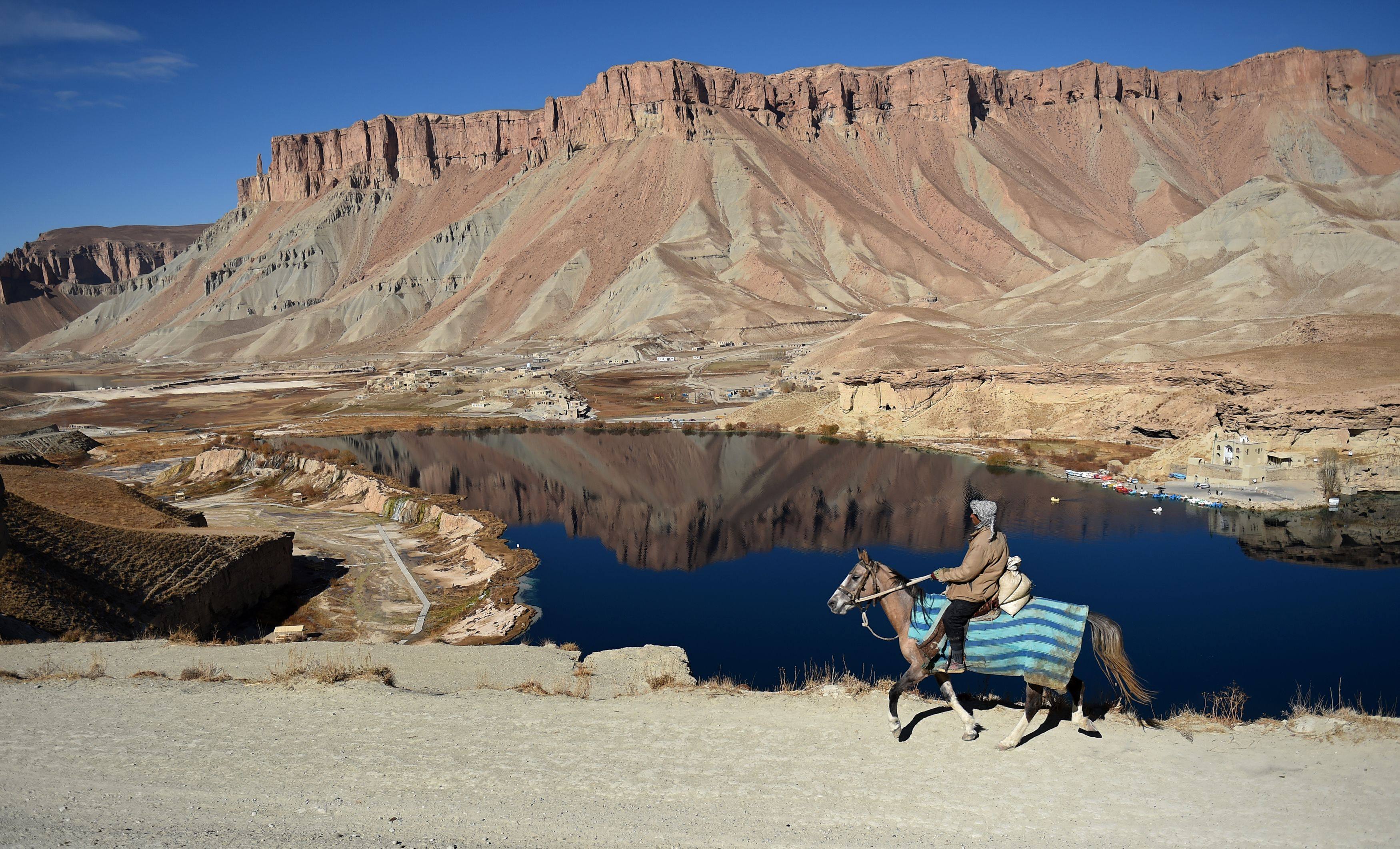 A man rides a horse by a lake in Band-e-Amir, the first national park in Afghanistan. File photo: AFP