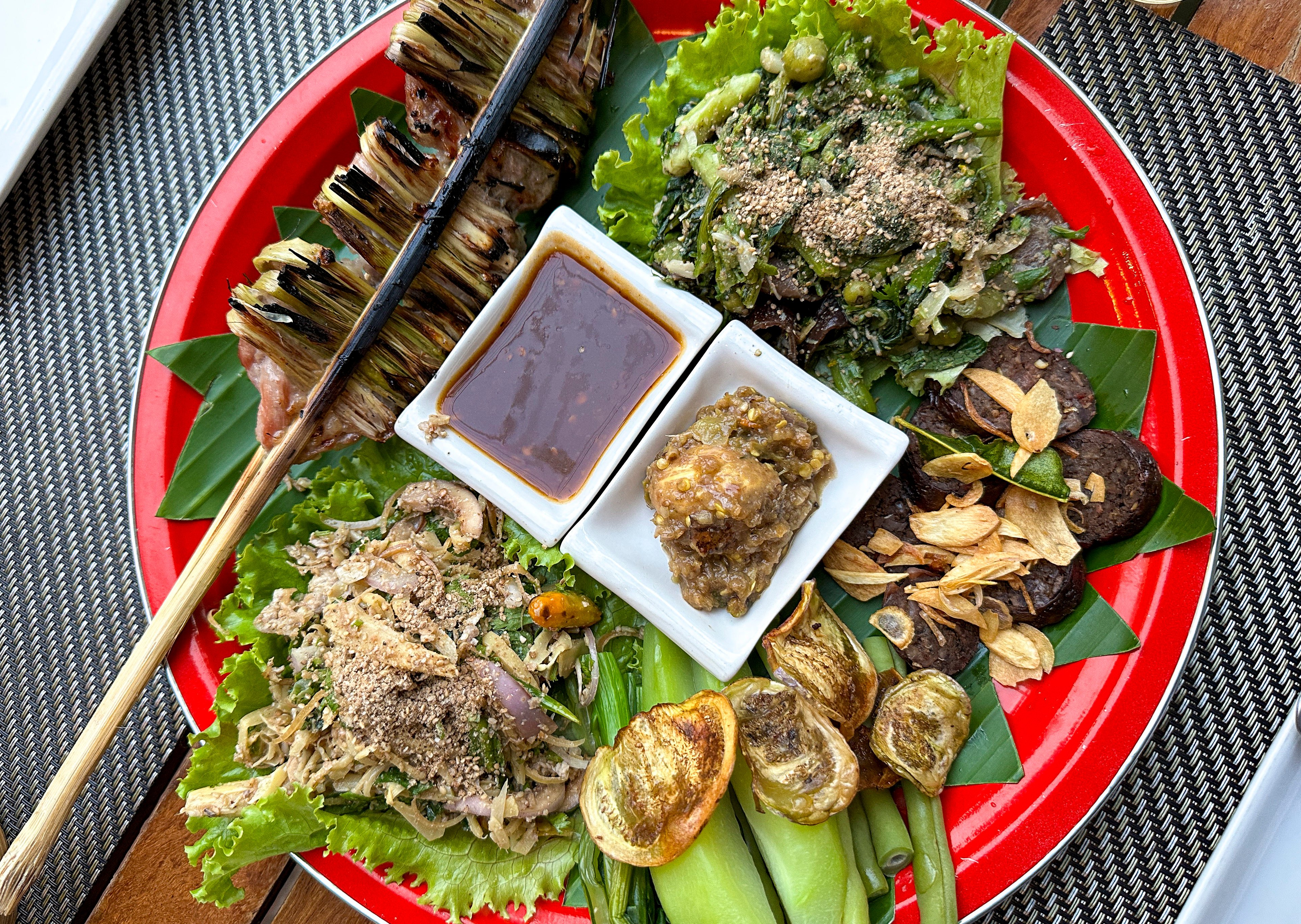 A platter at Tamarind in Luang Prabang of soured pork wrapped in lemongrass, eggplant chips and dips. Photo: Zinara Rathnayake