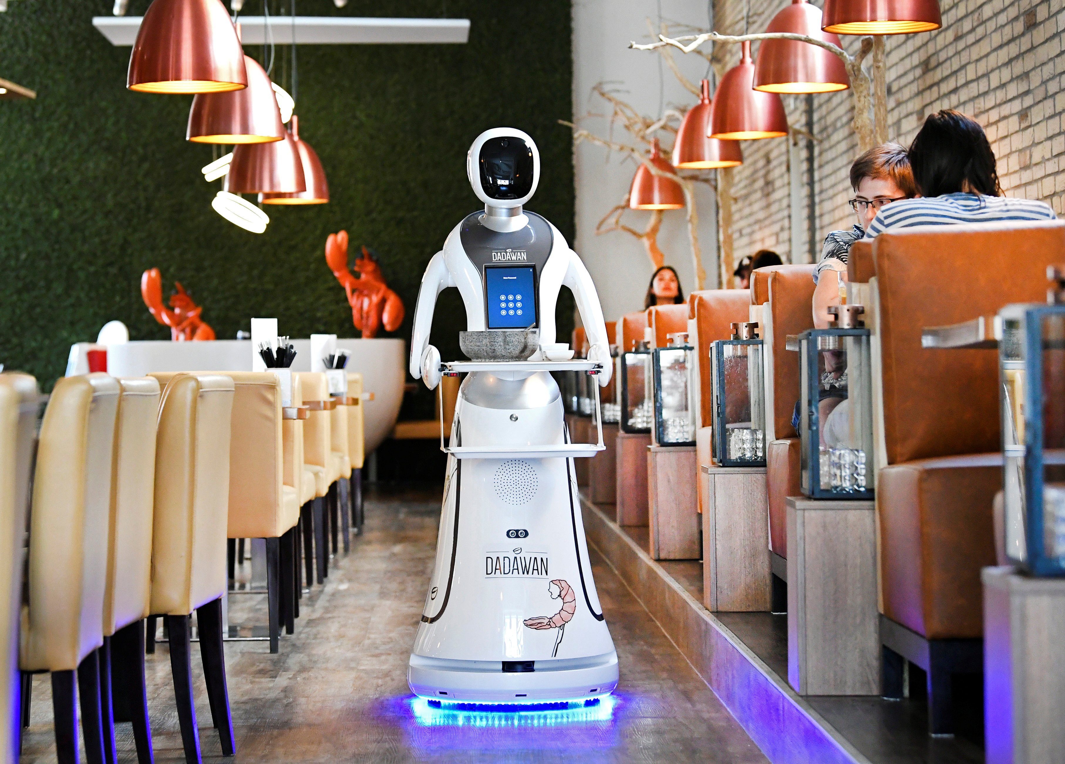 A robot waiter in a Chinese restaurant. South Korea has embraced robot waiters as a response to labour shortages caused in part by a demographic crisis. Photo: Reuters
