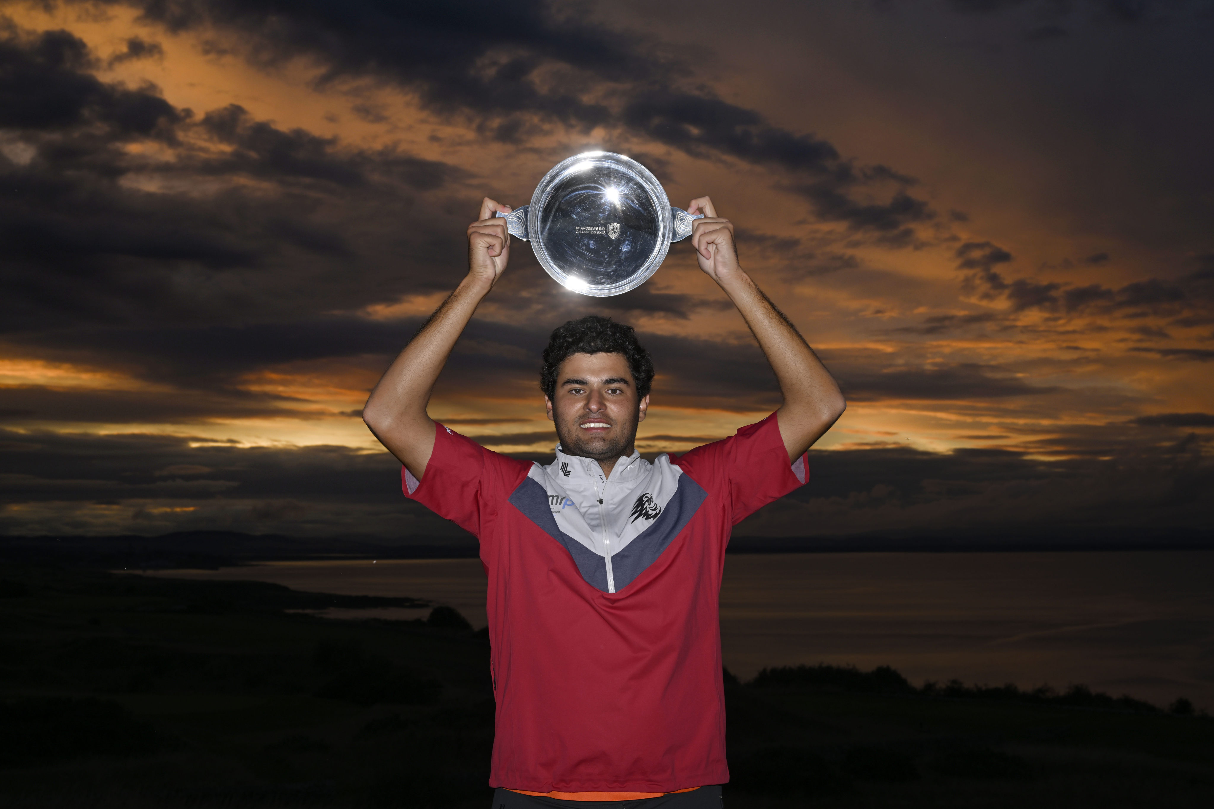Spain’s Eugenio Chacarra lifts the St Andrews Bay Championship winner’s trophy after his marathon play-off victory. Photo: Asian Tour