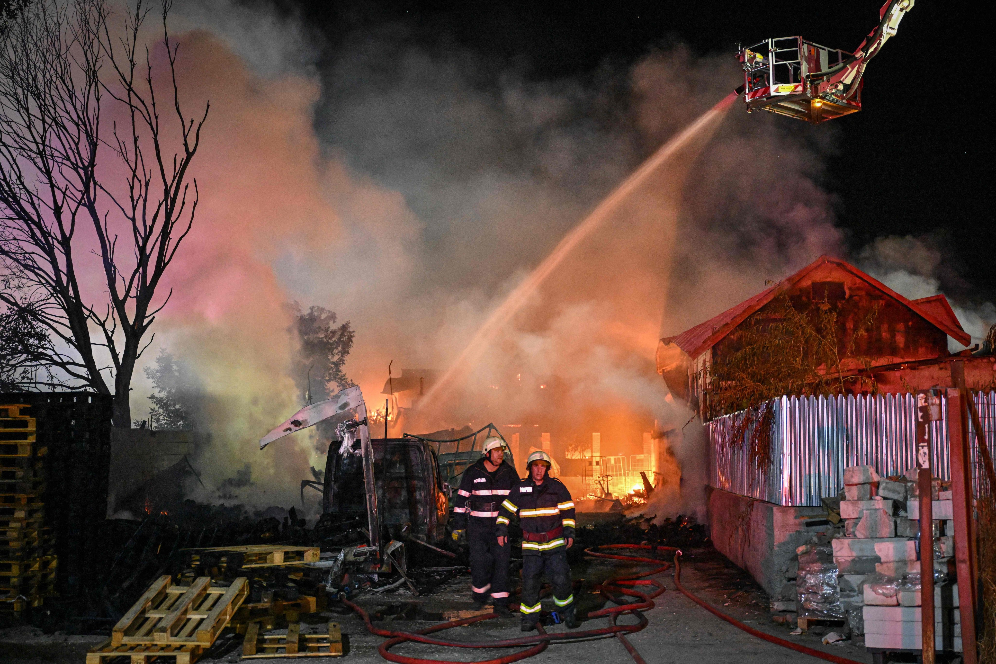 Firefighters attempt to extinguish flames in the village of Crevedia, near Bucharest, Romania early on Sunday. Photo: AFP