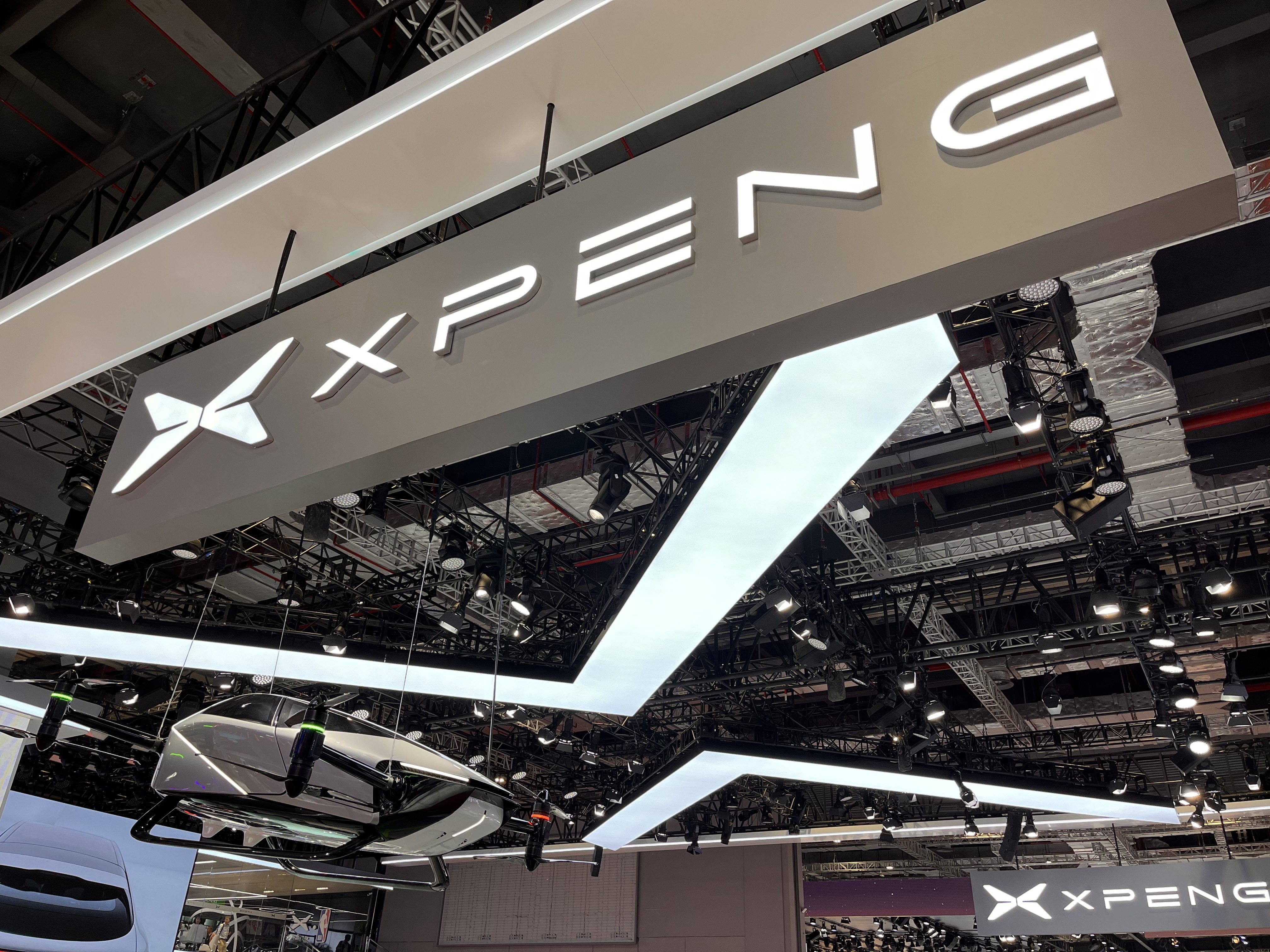 An Xpeng logo hangs over the company’s booth at the 20th Shanghai International Automobile Industry Exhibition at the National Exhibition and Convention Center in Shanghai on April 19, 2023. Photo: VCG via Getty Images