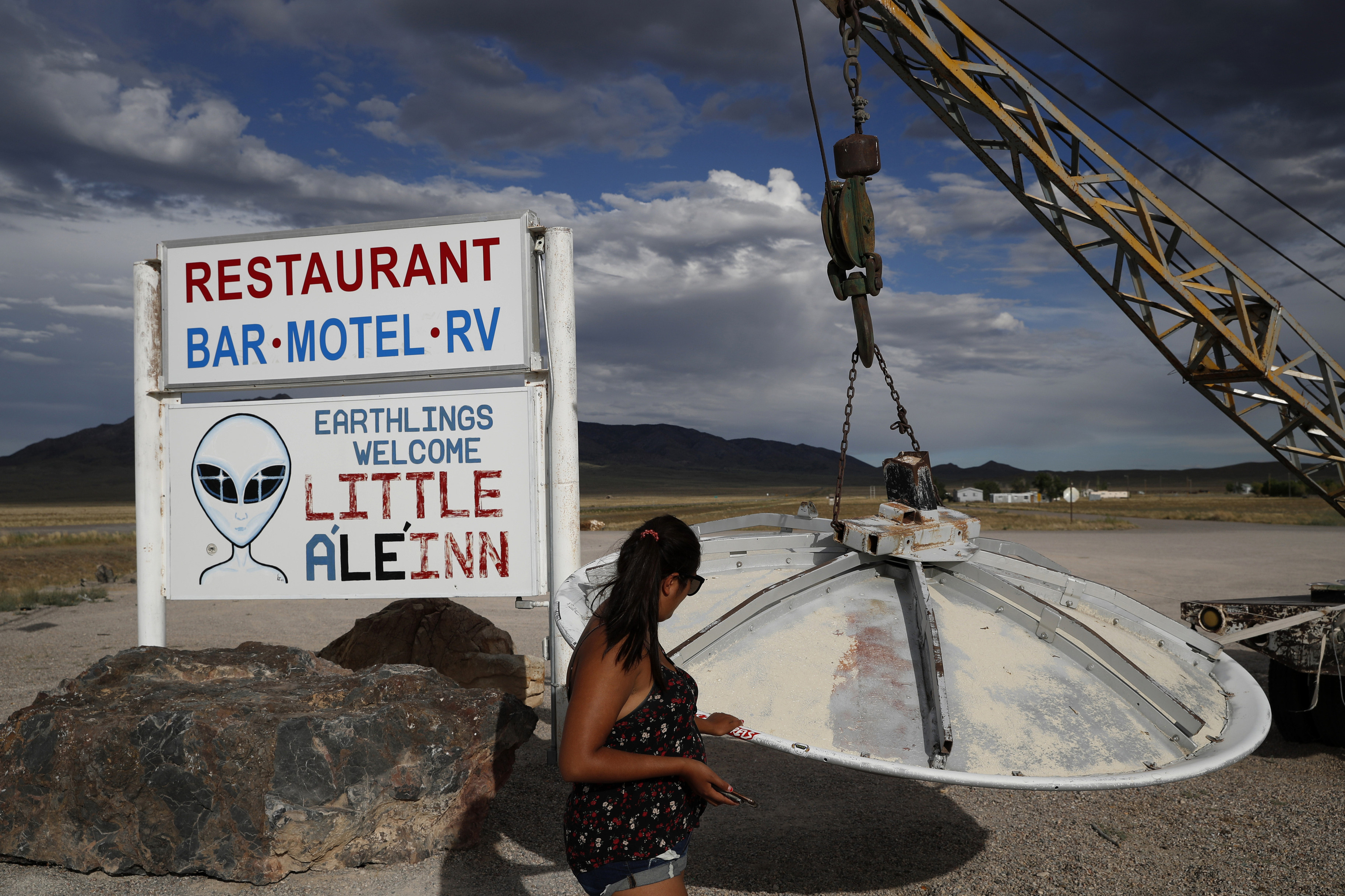 A woman looks at a UFO display outside of the Little A’Le’Inn, in Rachel, Nevada, the closest town to Area 51 on July 22, 2019. Photo: AP
