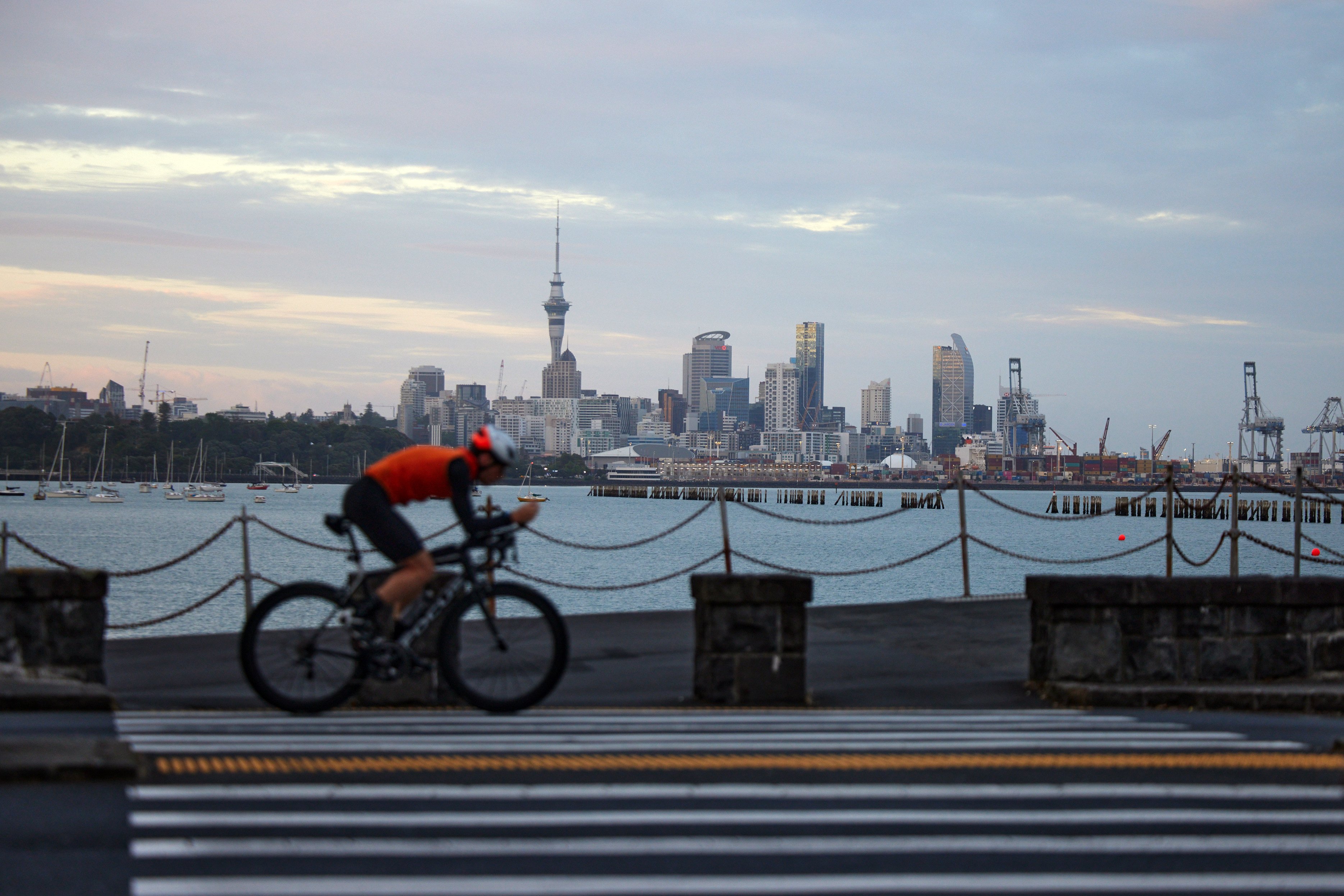 A cyclist rides past Auckland’s skyline. The country’s defence policy and strategy statement said “New Zealand is facing a more challenging strategic environment than it has in decades”. Photo: Bloomberg
