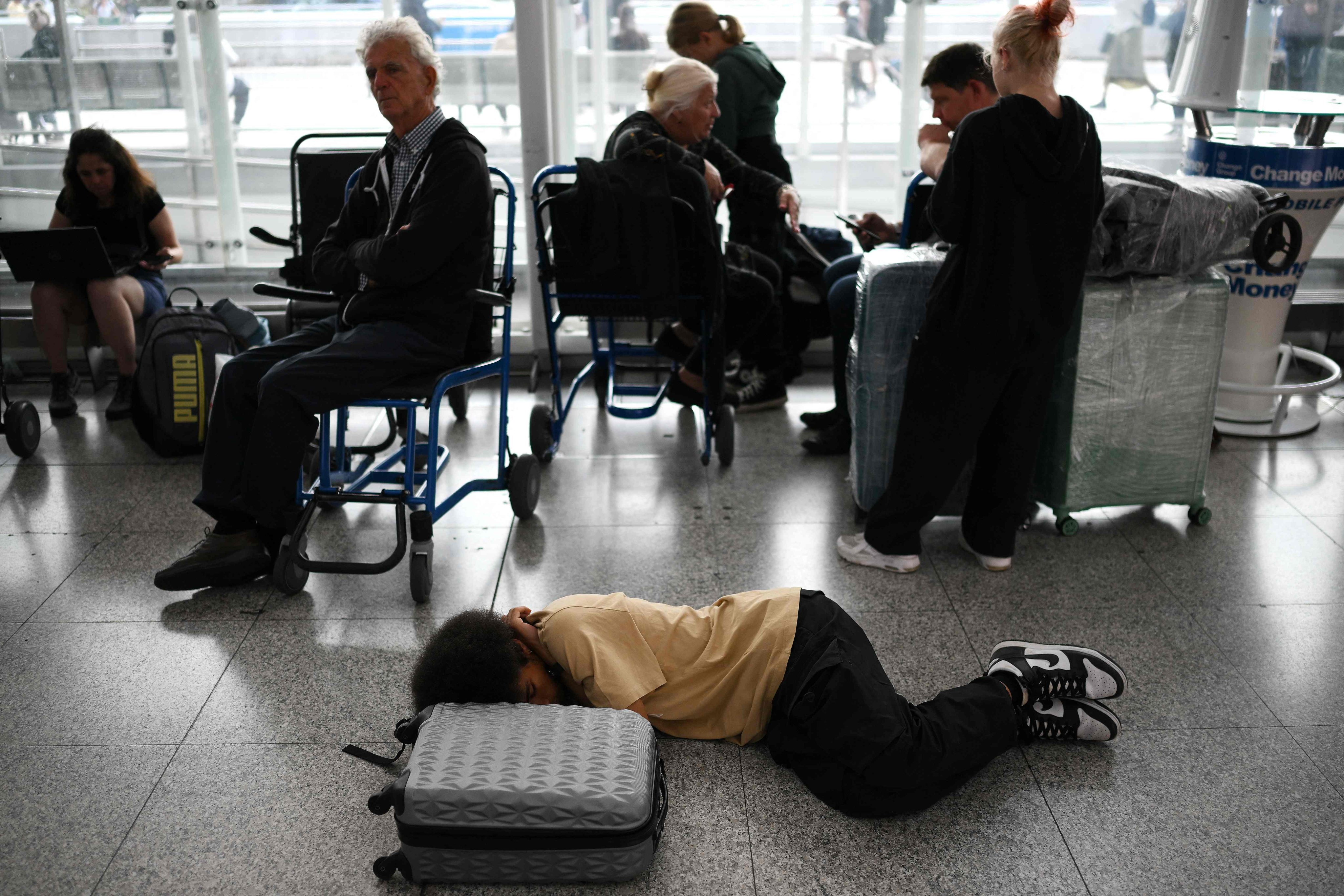 Passengers wait at Stansted Airport, north of London, after UK flights were delayed over a technical issue. Photo: AFP