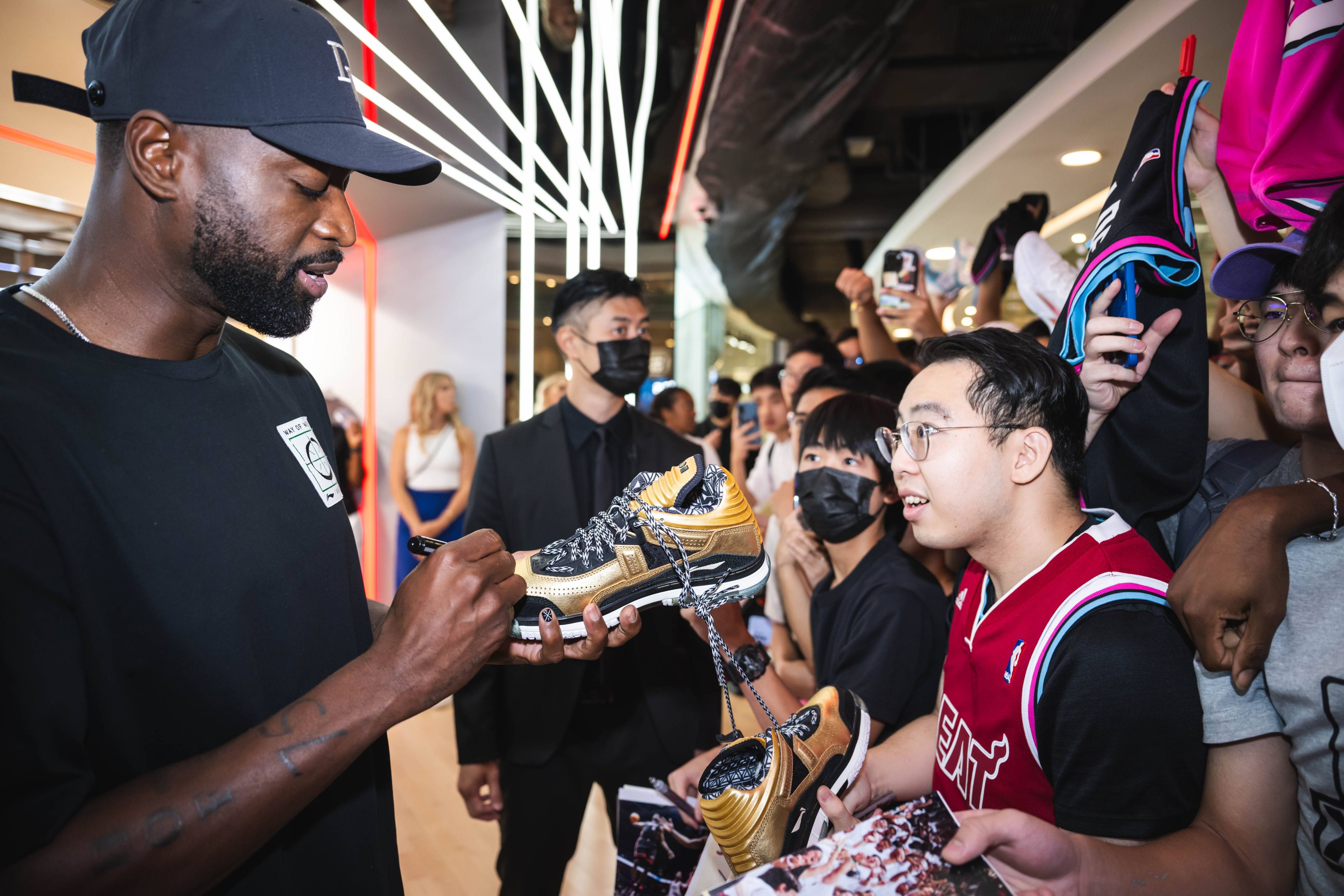 Dwyane Wade signs shoes brought by fans in Hong Kong. Photo: Handout