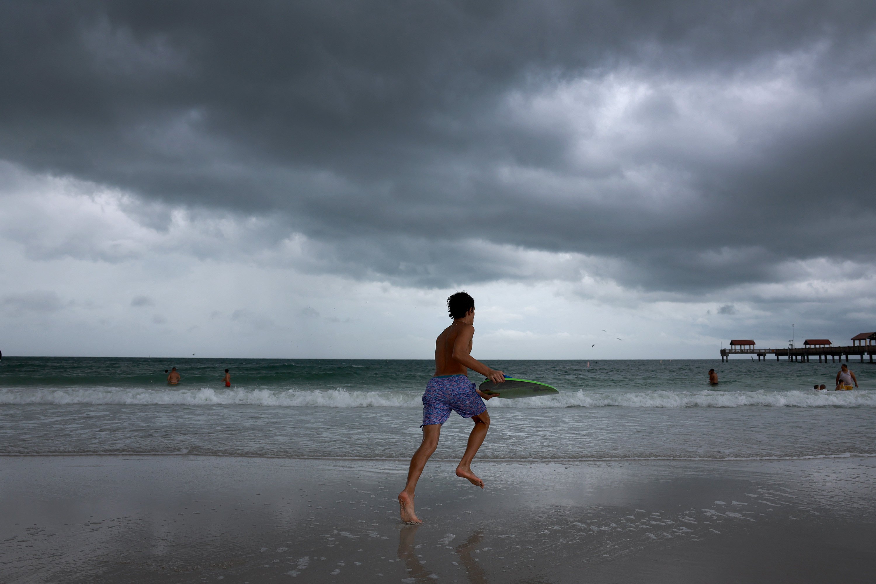 Storm clouds hang over beachgoers before the possible arrival of Hurricane Idalia in Clearwater Beach, Florida, on Tuesday. Photo: AFP