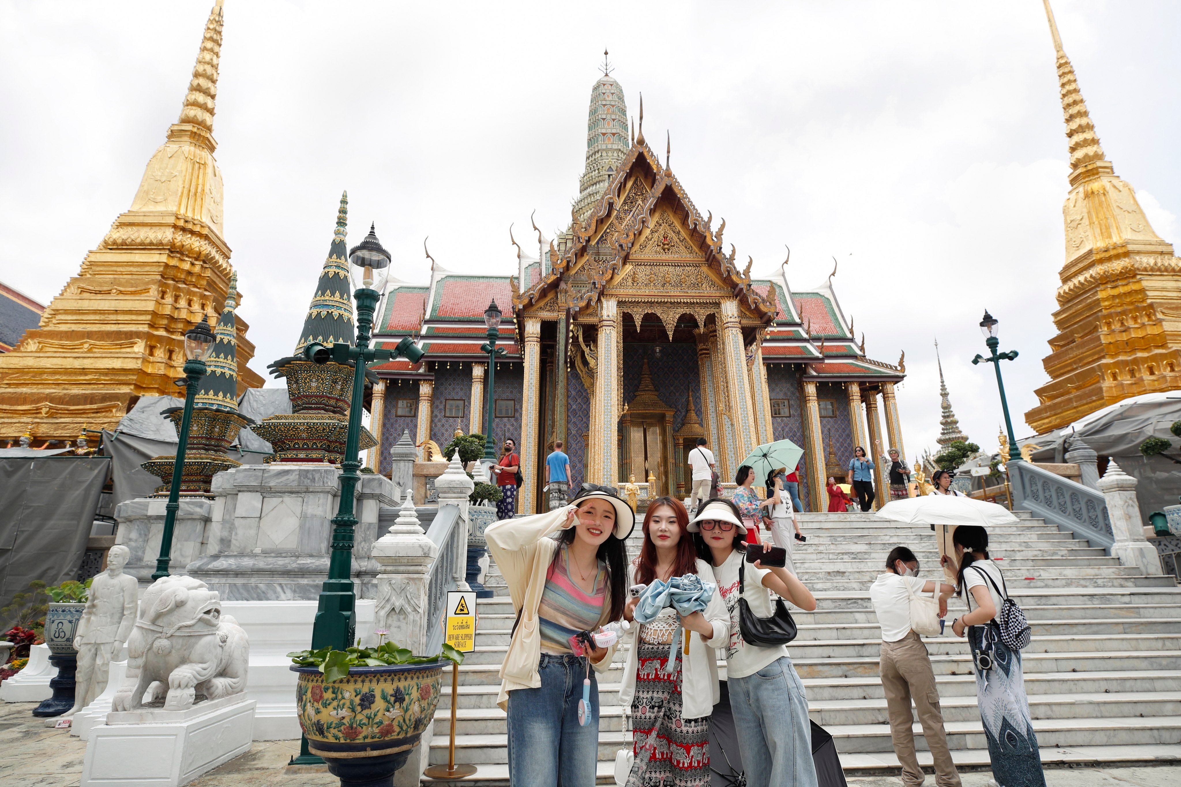 Chinese tourists visit the Temple of the Emerald Buddha in Bangkok earlier this year. Photo: EPA-EFE