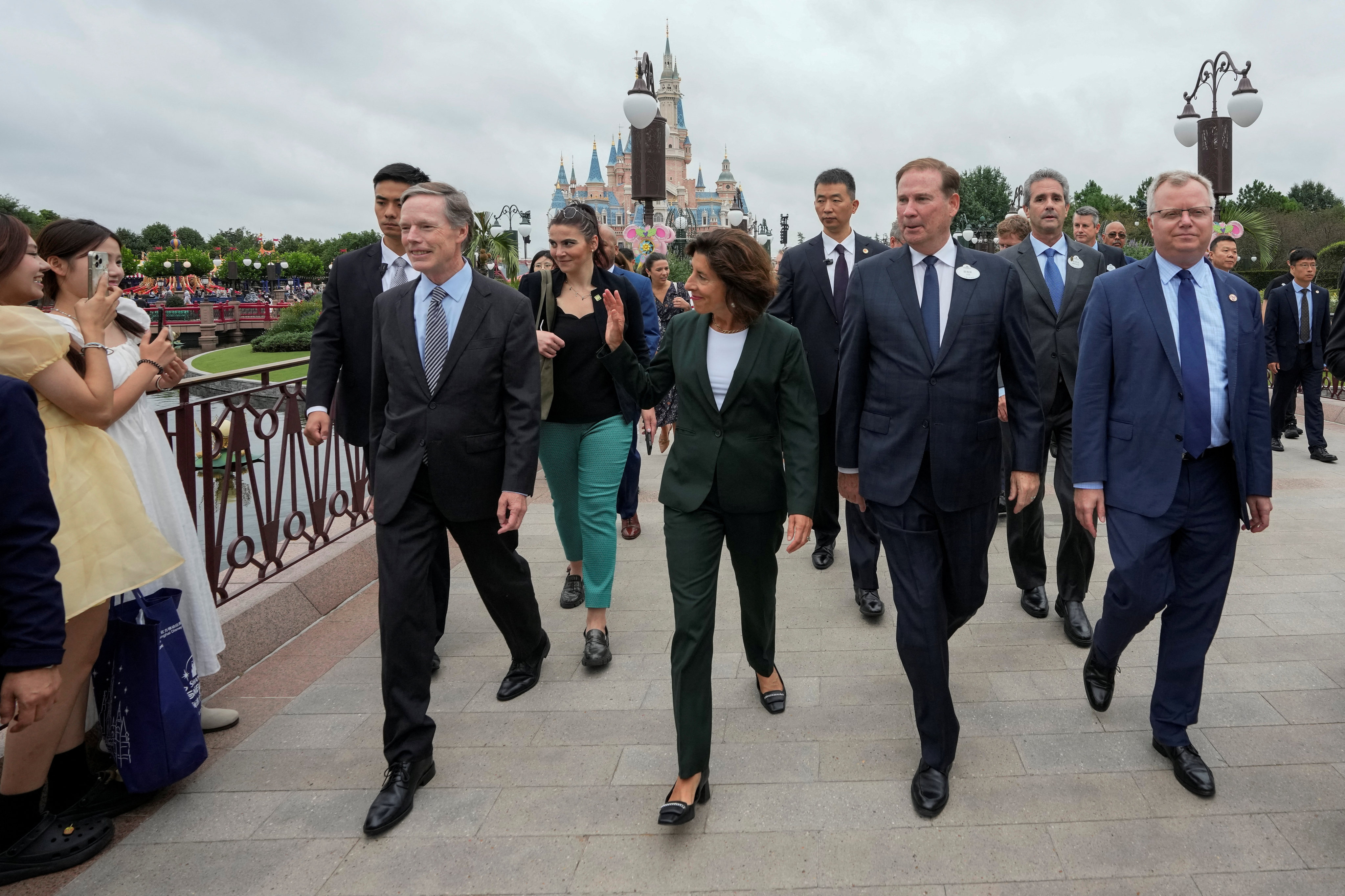 US Commerce Secretary Gina Raimondo is escorted by officials as she tours Shanghai Disneyland. Photo: Reuters