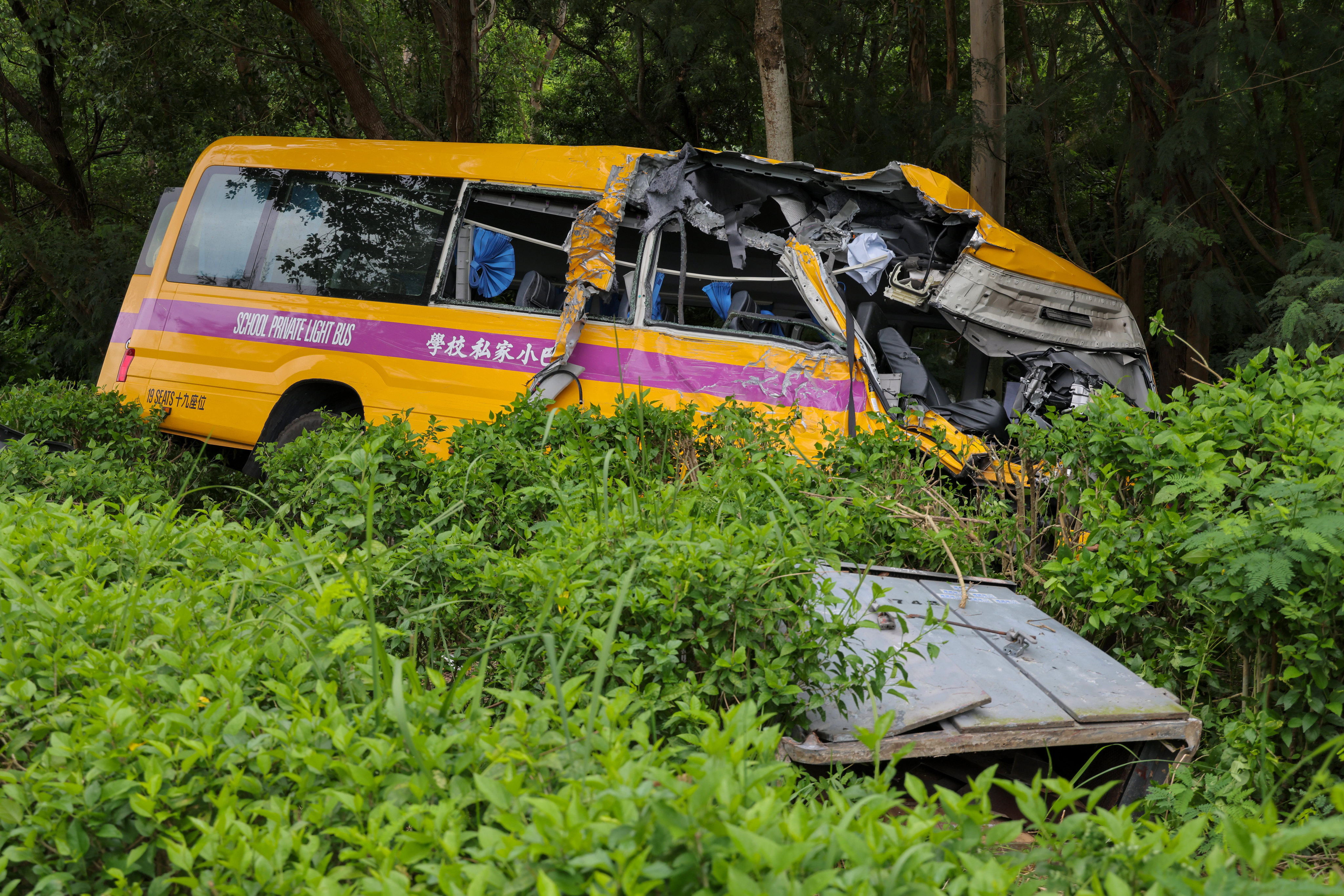 After it collided with the double-decker vehicle, the school bus veered off the single lane road and crashed into the trees, leaving its front half damaged. Photo: Jelly Tse