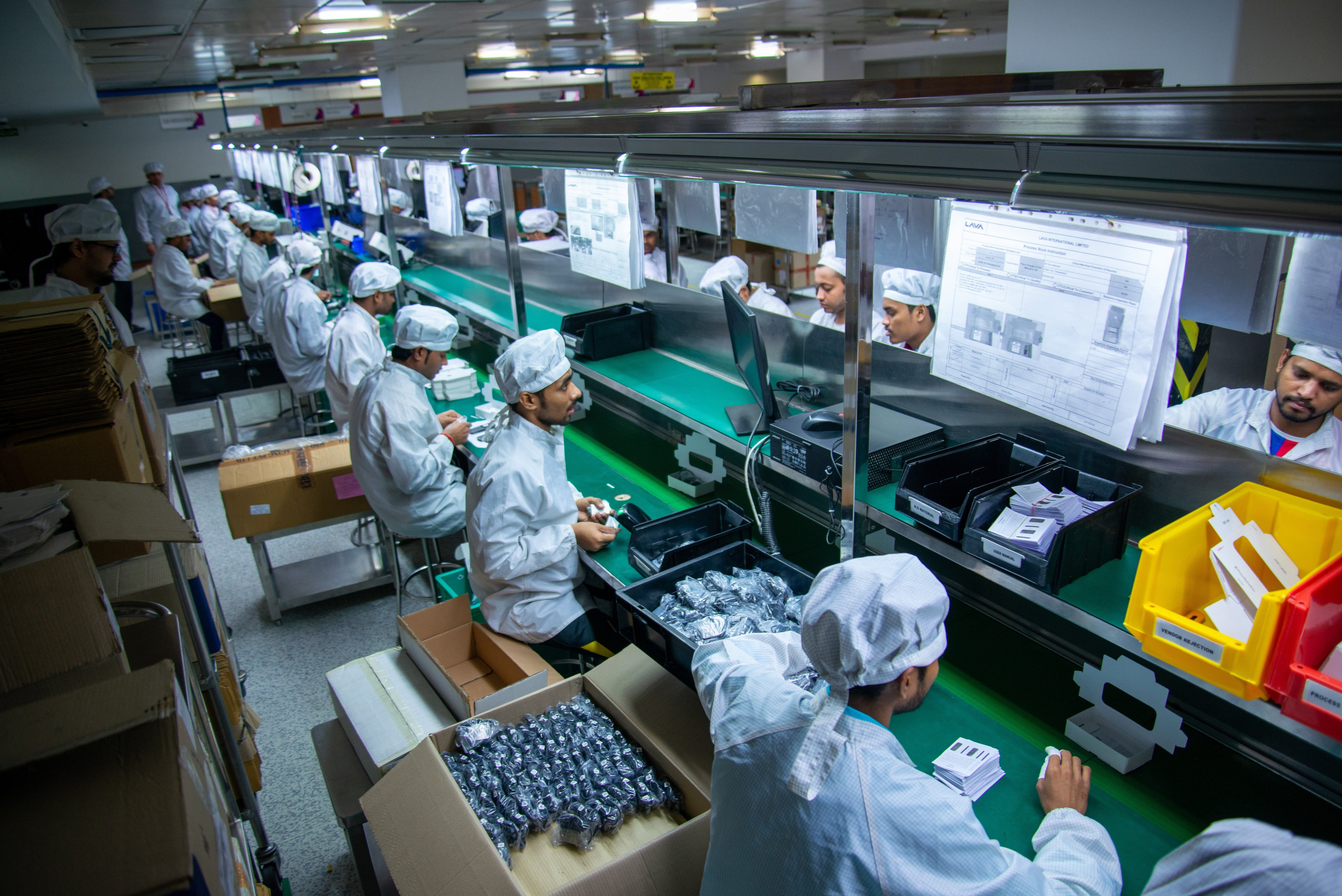 A group of technicians working in a mobile manufacturing plant in Noida, India, on October 23, 2019. Photo: Shutterstock