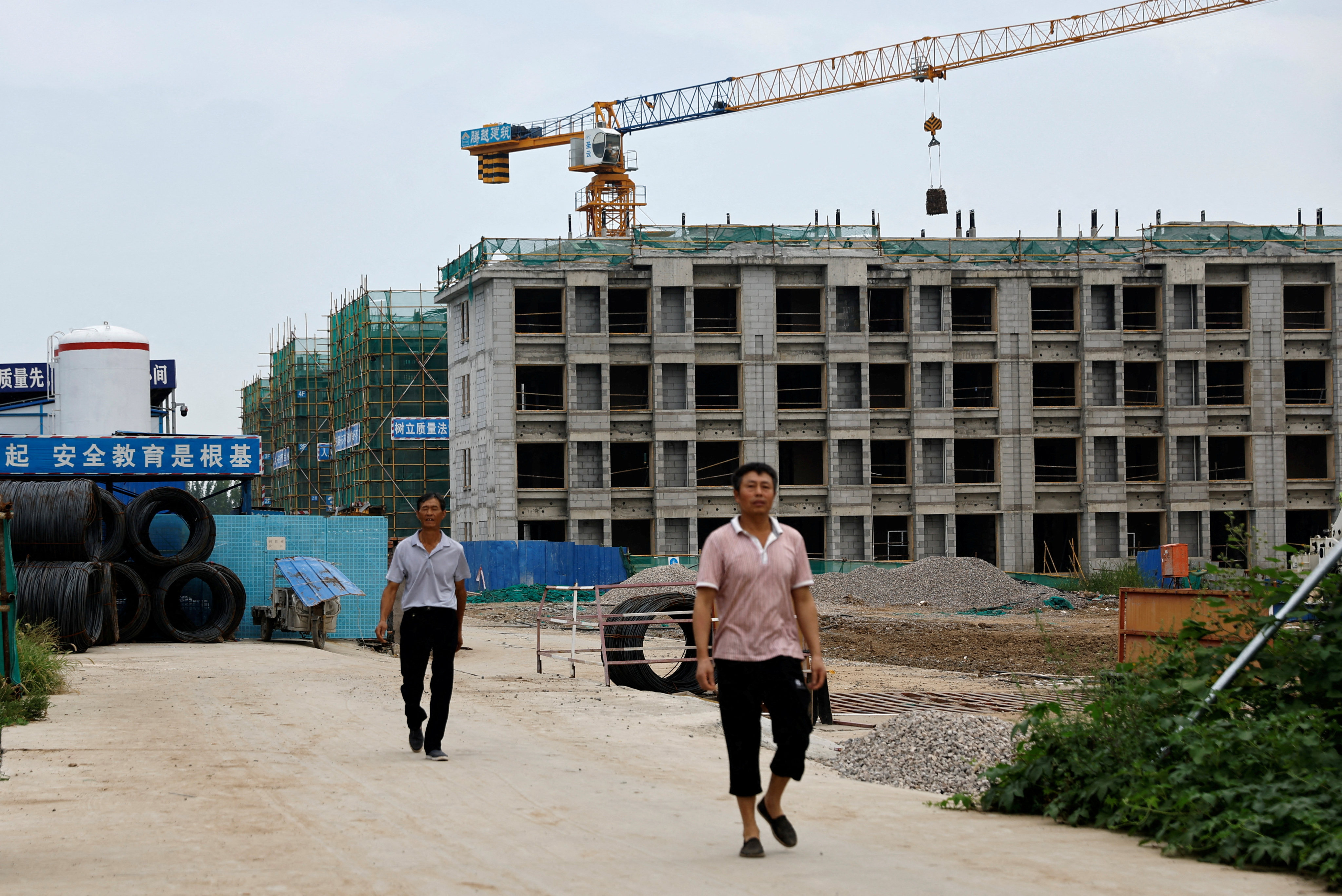 Workers leave a construction site for residential buildings by Chinese developer Country Garden in Tianjin on August 18. The struggles of the property sector have weighed on the country’s economy, but China’s unique blend of openness and state control makes it unlikely to have a “Lehman moment” that rocks global markets. Photo: Reuters