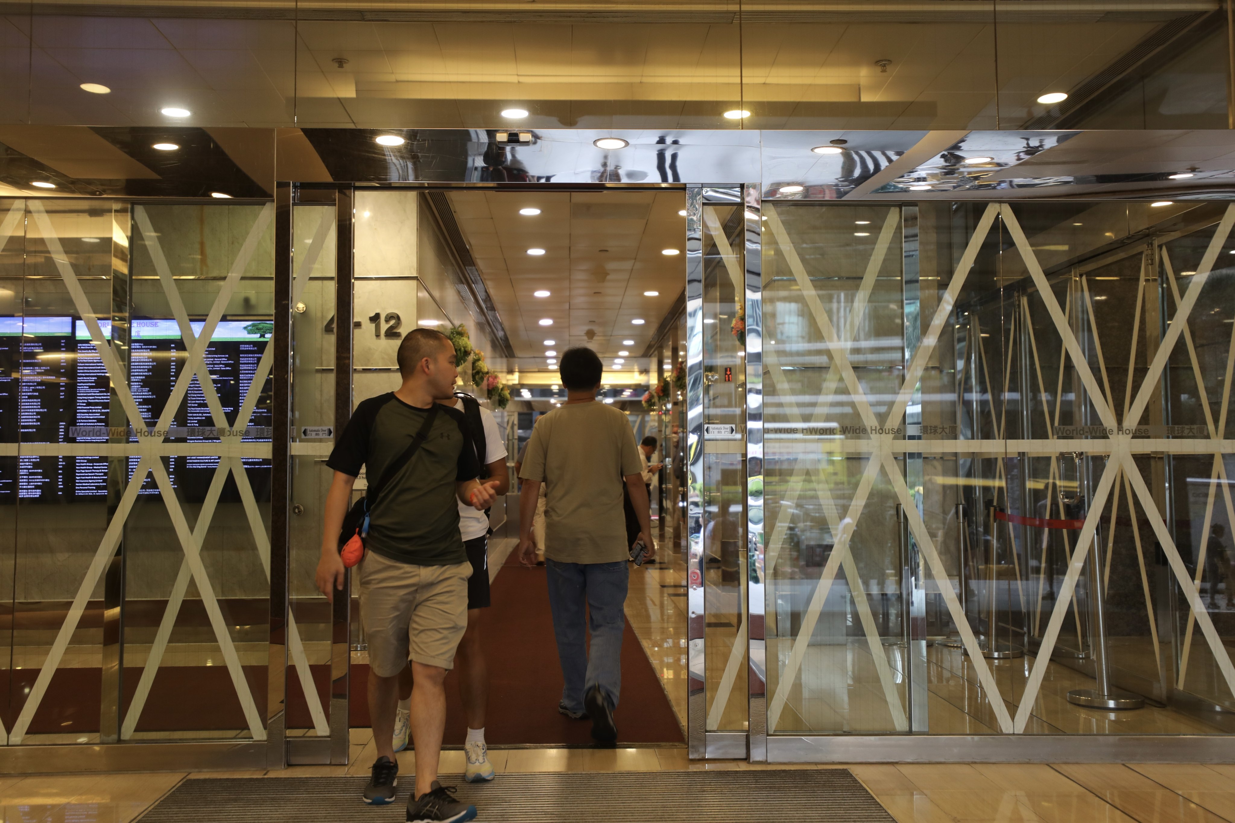 A glass door is taped in Central as Hong Kong Observatory issued signal 3 typhoon on 31 August, 2023. Photo: Xiaomei Chen.