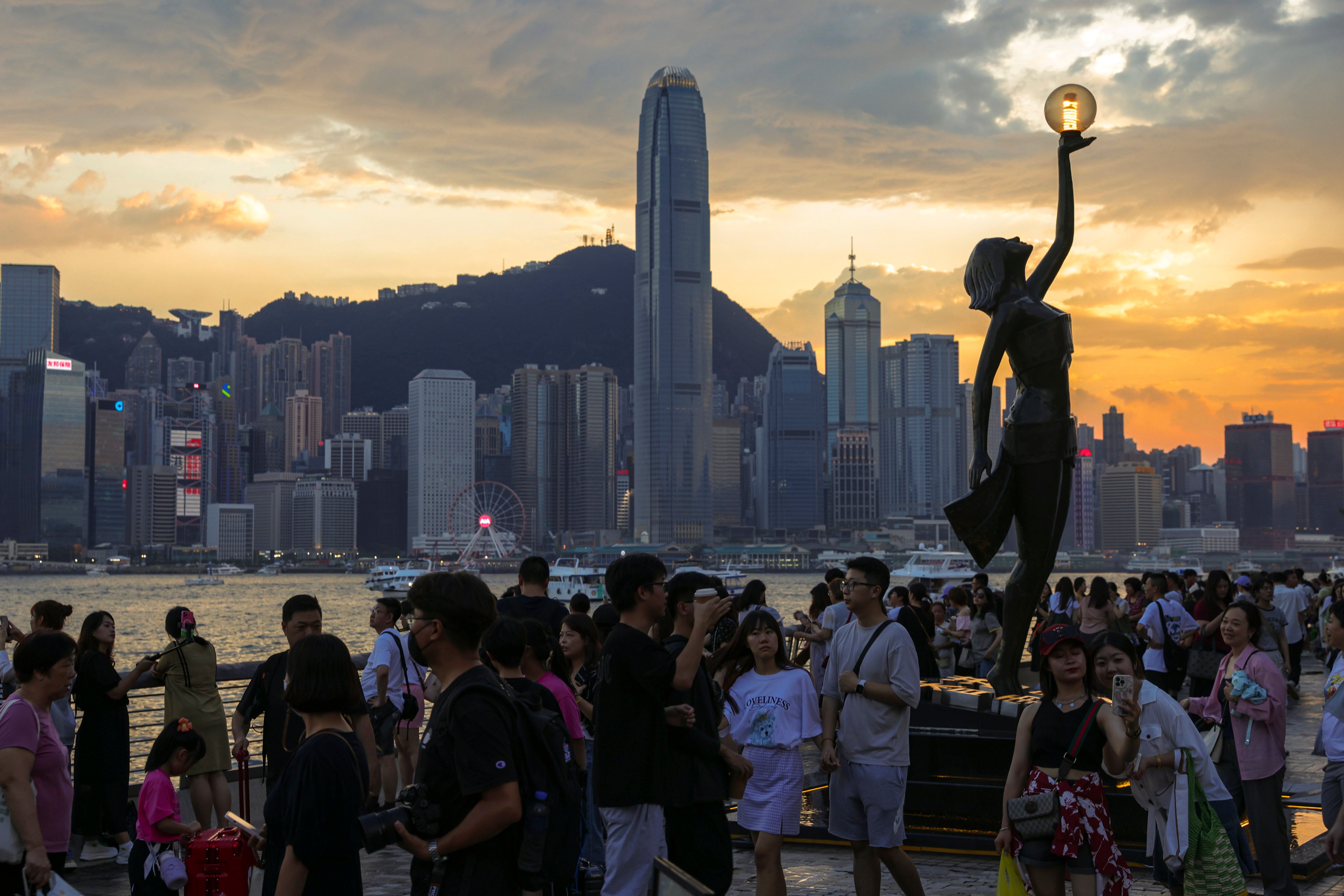Tourists gather at the Avenue of Stars in Tsim Sha Tsui, with the skyline of Hong Kong’s central business district behind them, on July 15. Photo: Yik Yeung-man