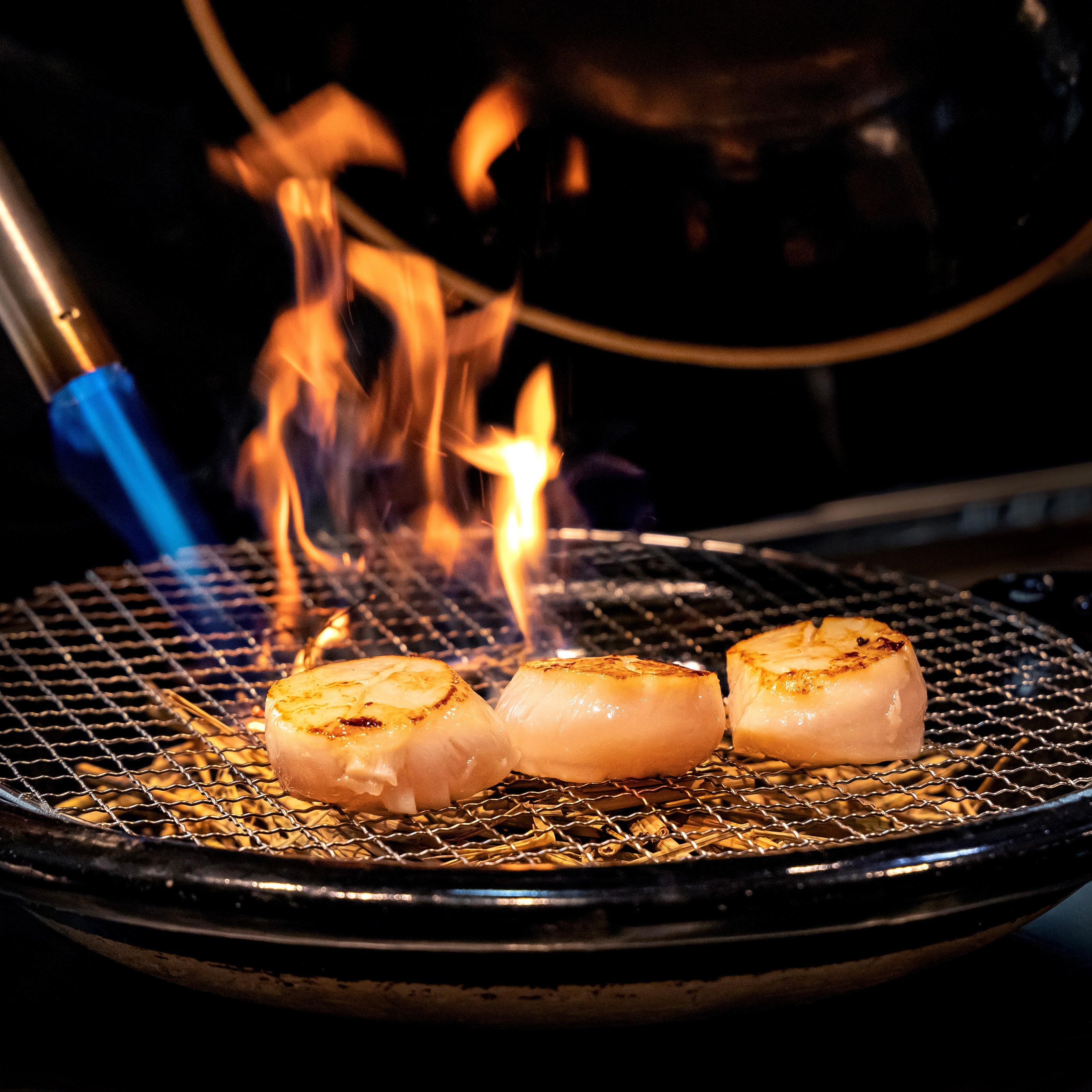 At Miyoshi, signature straw-smoked Hokkaido scallop is first grilled on the teppan for a light crust, before being smoked with straw to infuse an earthy aroma. Photo: Miyoshi