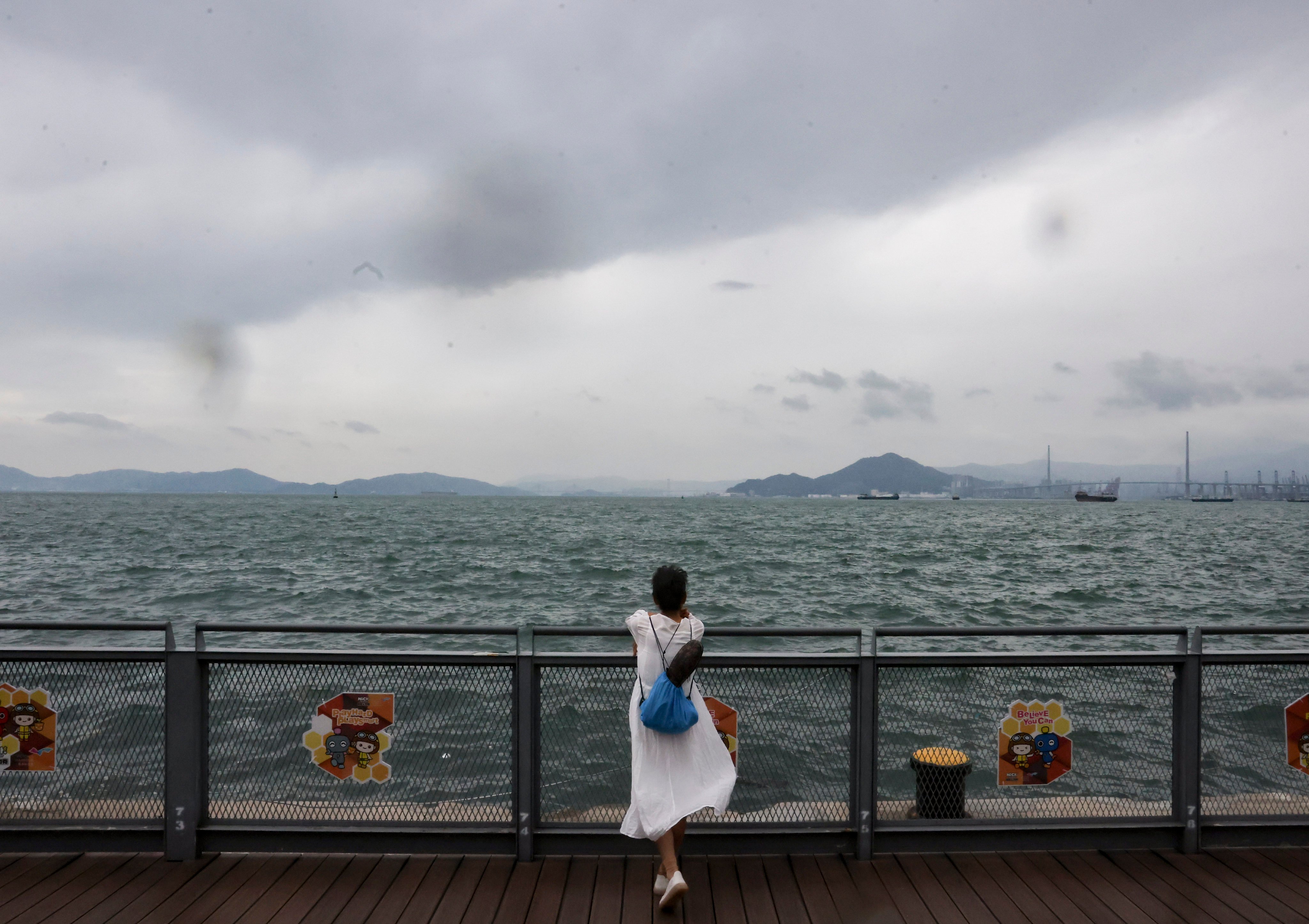 A resident watches the water rise near Belcher Bay Promenade in Kennedy Town as Super Typhoon Saola approaches Hong Kong. Photo: Jonathan Wong