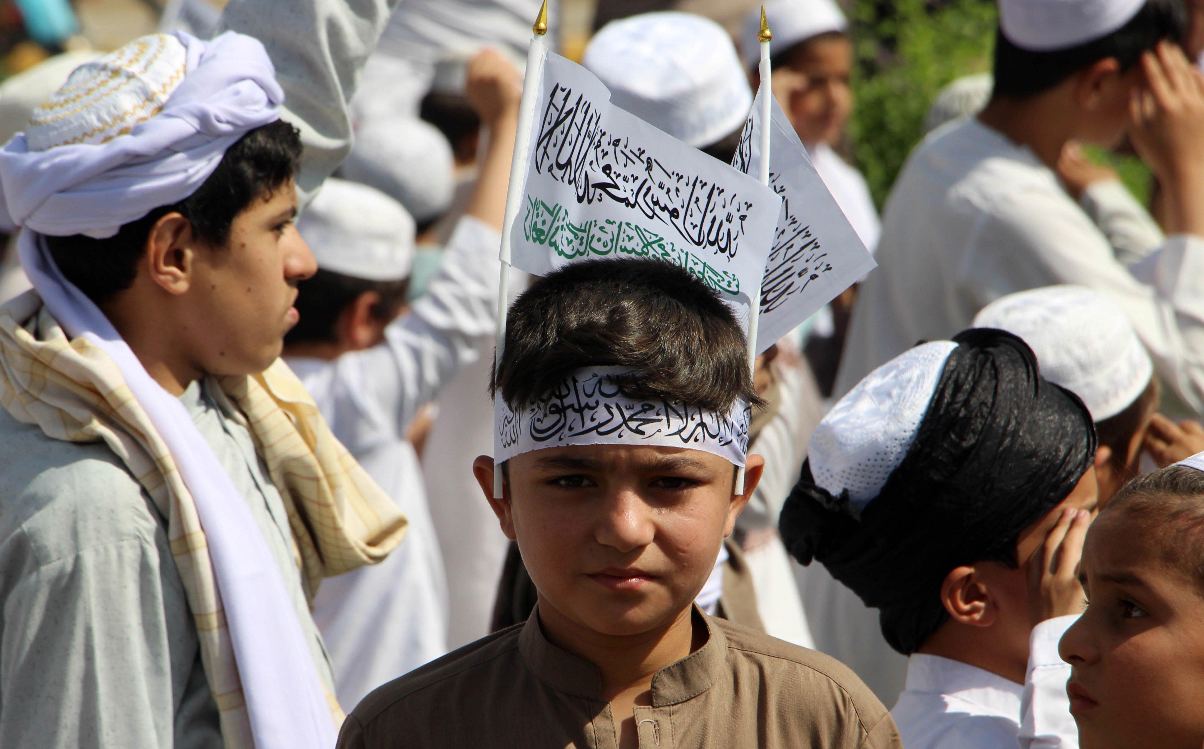 Afghan boys gather to mark the second anniversary of the US withdrawal, in Kandahar, Afghanistan, on August 31. With its extreme interpretation of Islam, the Taliban is seeking to turn Afghanistan into an ideological state. Photo: EPA-EFE