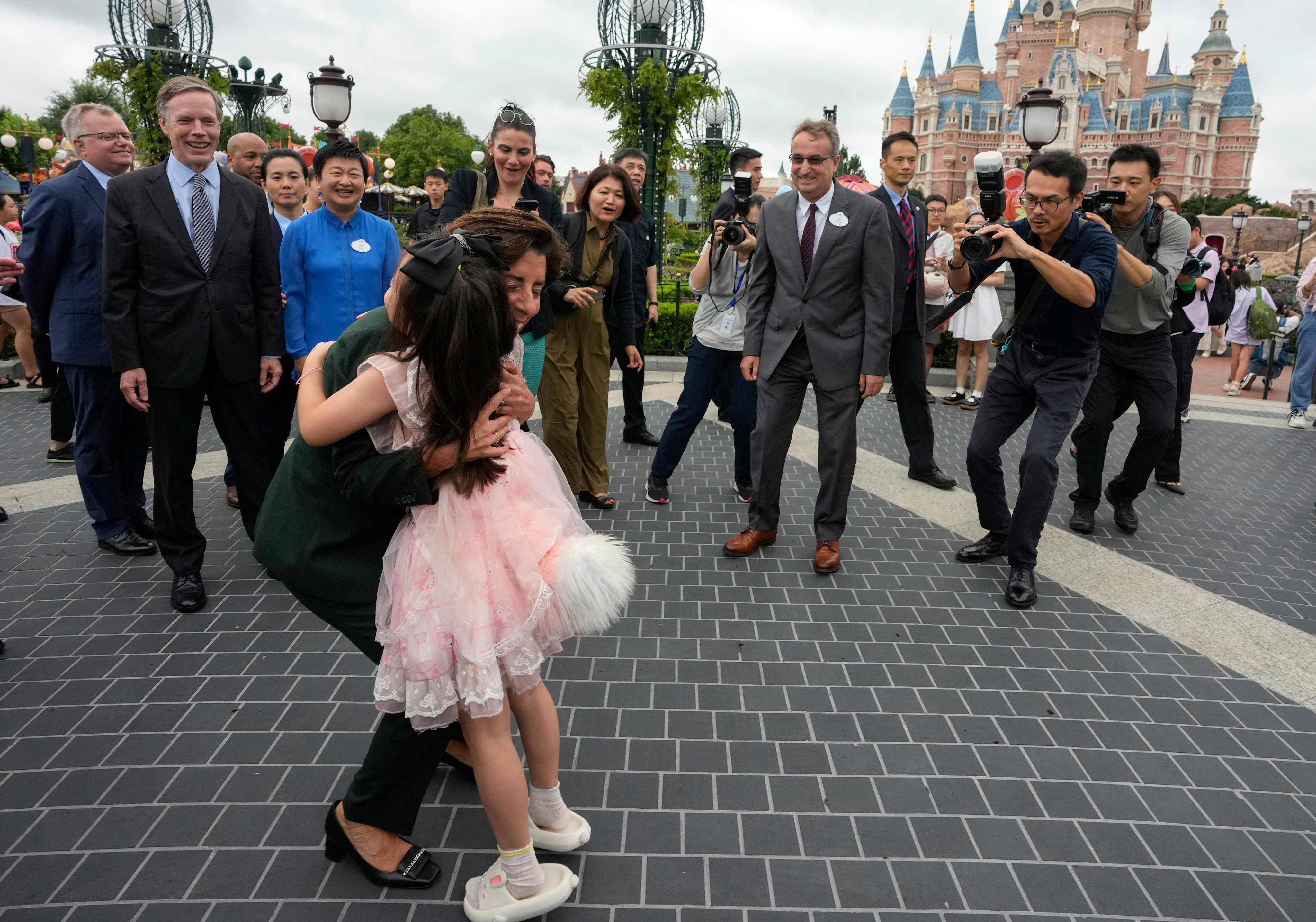 US Commerce Secretary Gina Raimondo embraced a girl wearing a costume at the Shanghai Disney Resort on August 30, 2023. Photo: AFP