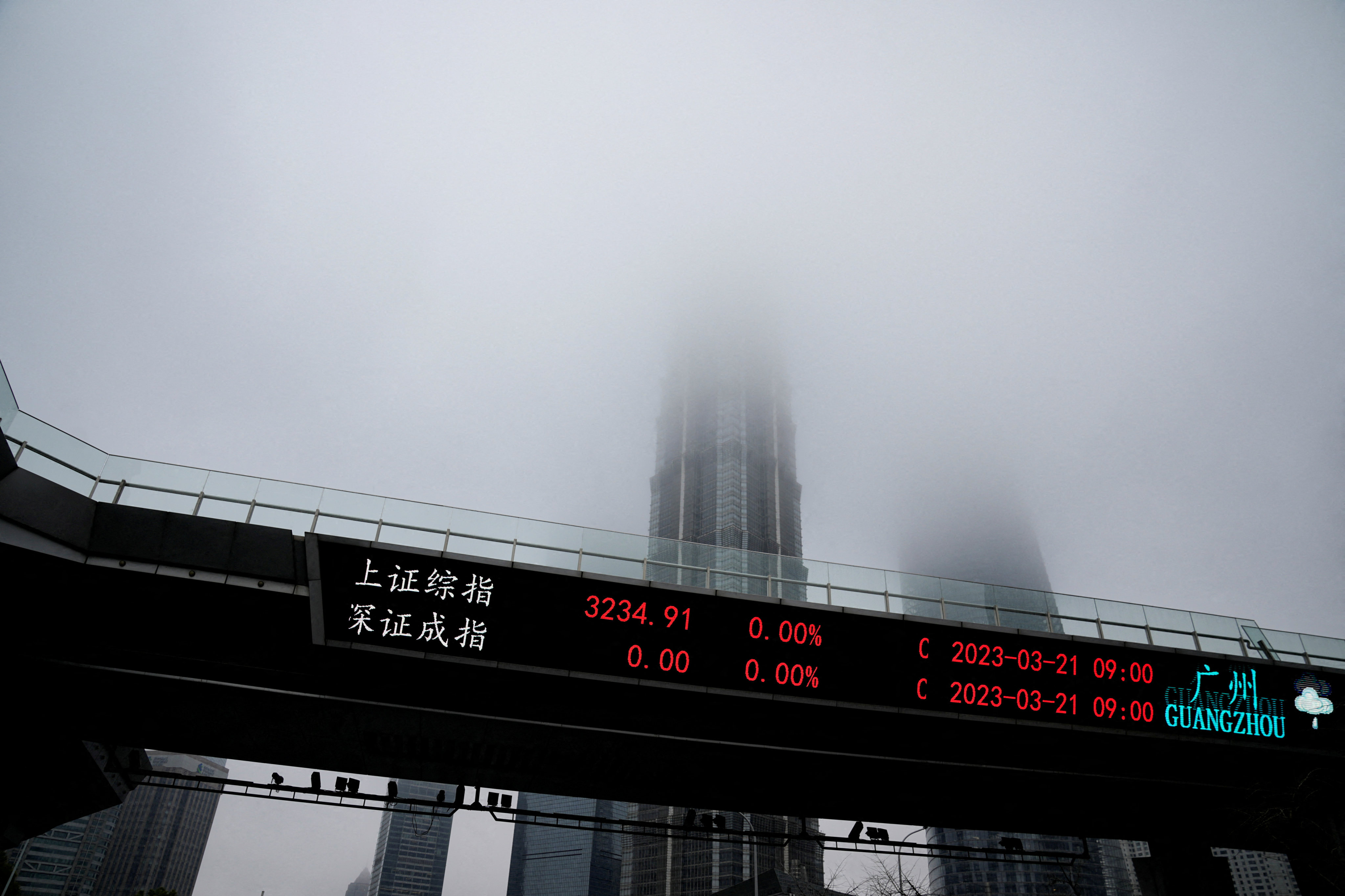 An electronic board shows stock indexes at the Lujiazui financial district in Shanghai on March 21. Photo: Reuters