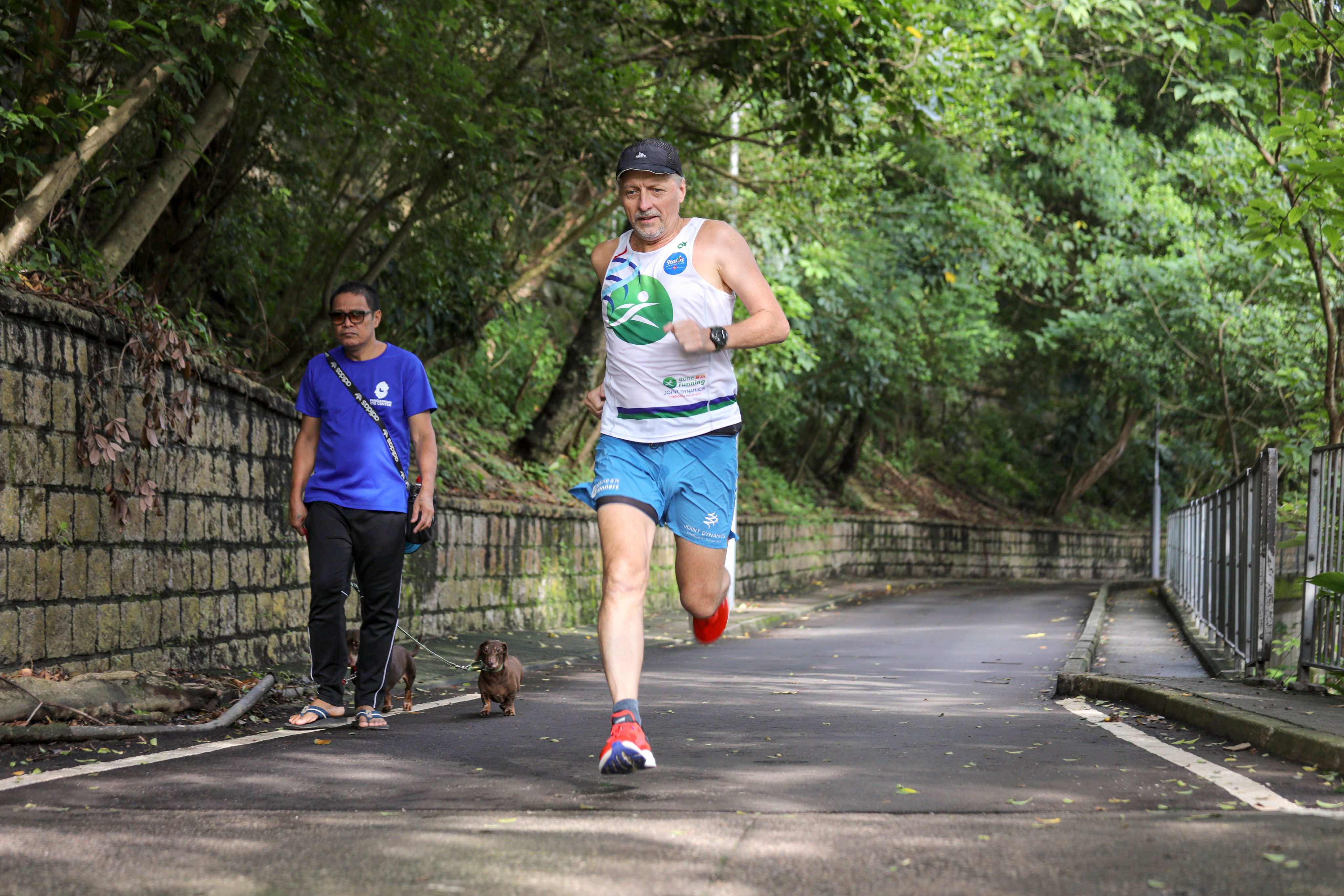Peter Hopper, 64, runs on Bowen Road, Hong Kong. The running coach set himself a challenge on his 60th birthday – to run at least 5km a day for 10 years. He’s kept it up for four years, averaging over 10km a day. Photo: Xiaomei Chen